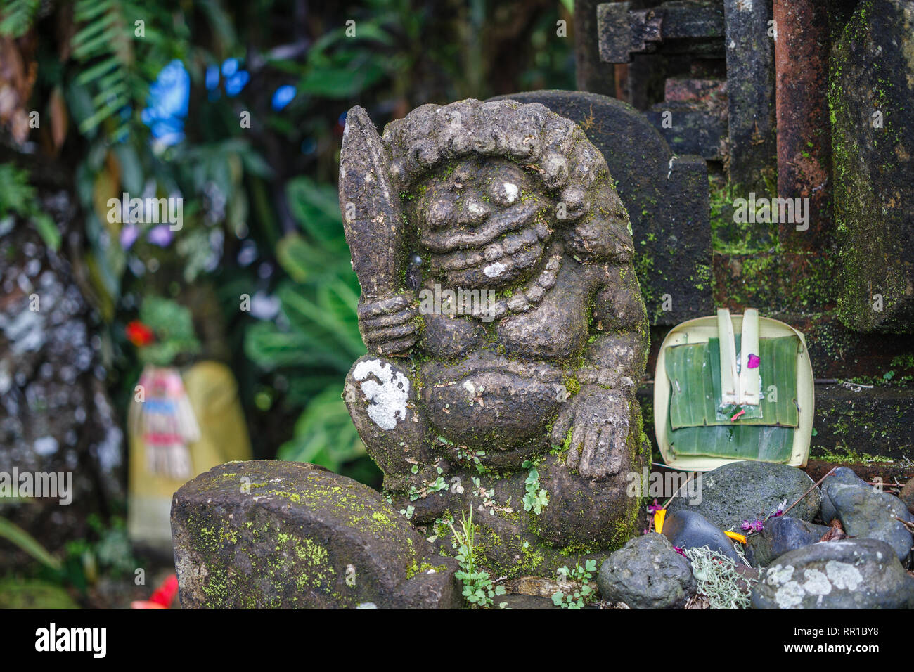Stone carved statue of a men with a sward. Bedugul, Bali, Indonesia. Stock Photo