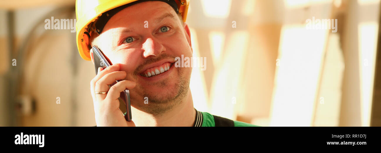 Carpenter talking on phone in hardware store Stock Photo