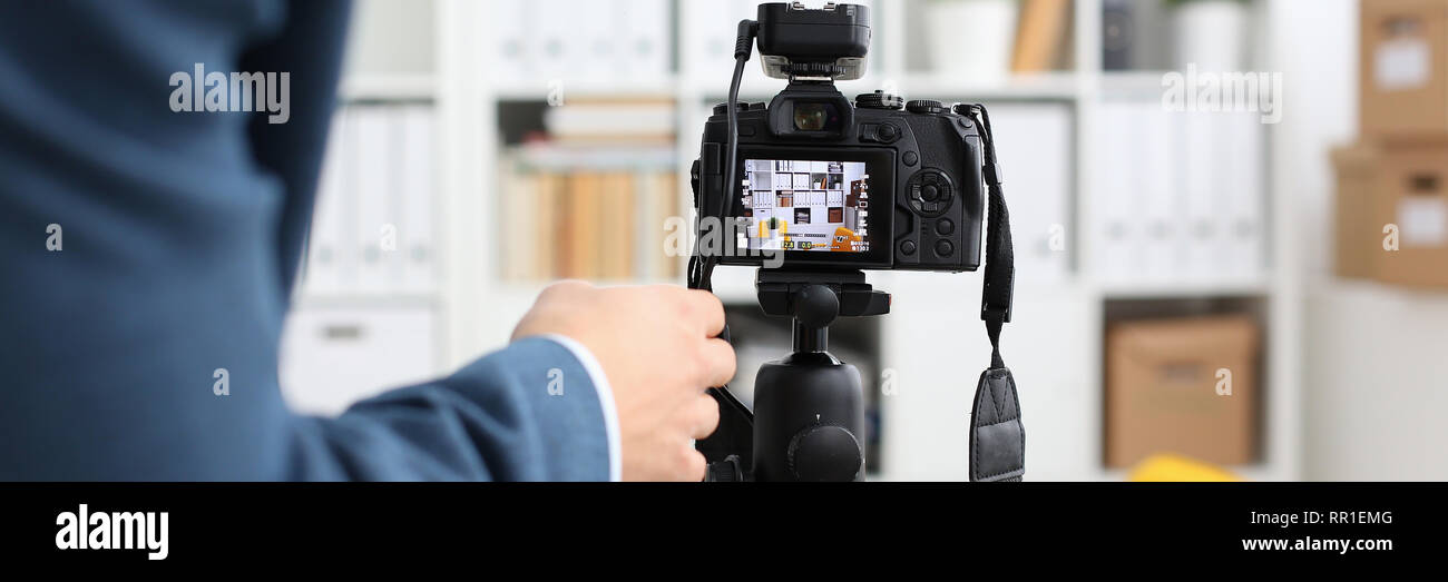 Male arms in suit mount camcorder to tripod Stock Photo Alamy