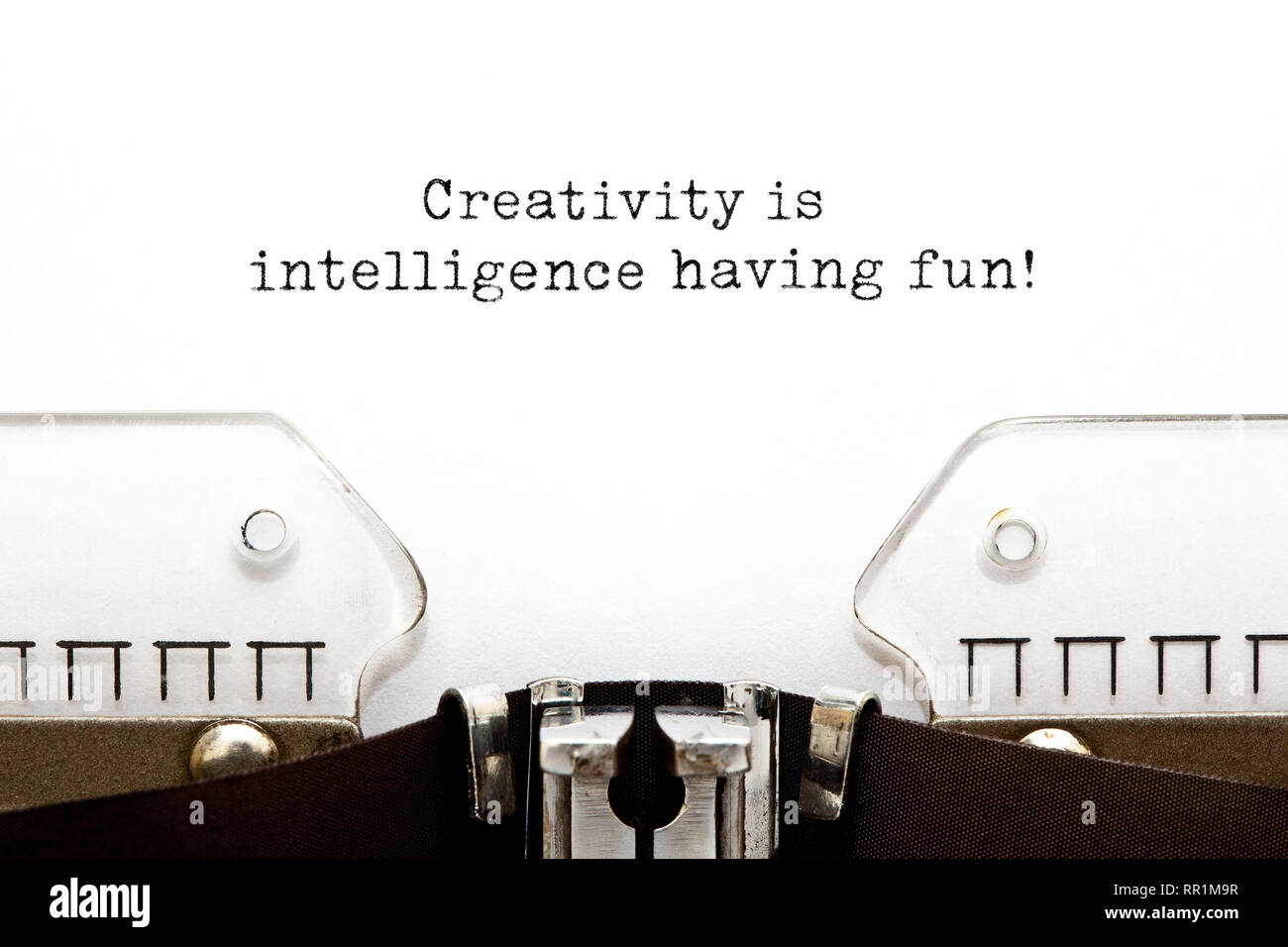 Inspirational quote Creativity Is Intelligence Having Fun typed on vintage typewriter. Stock Photo