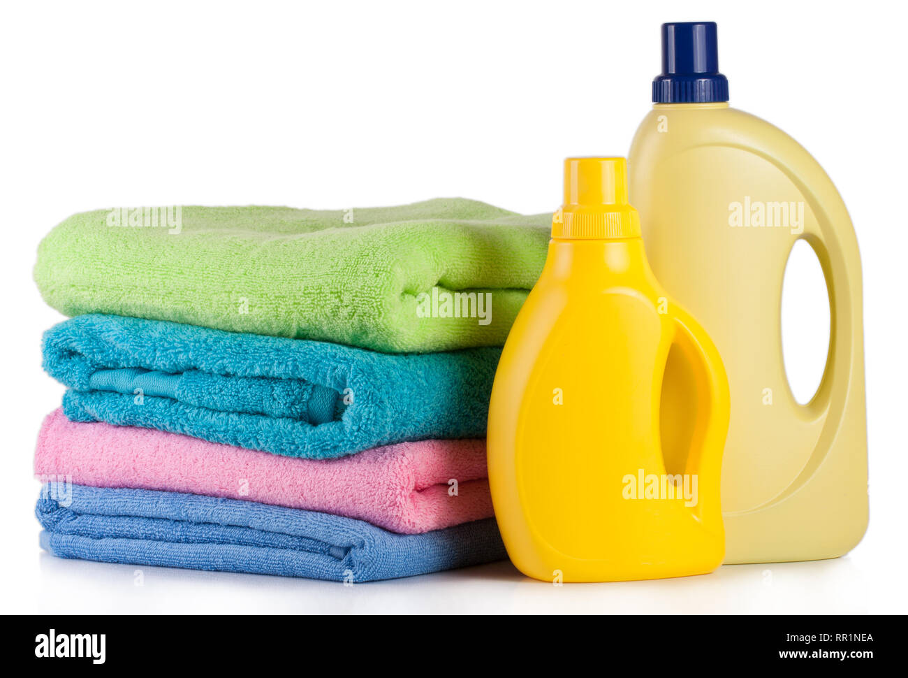 bottle laundry detergent and conditioner with towels isolated on white