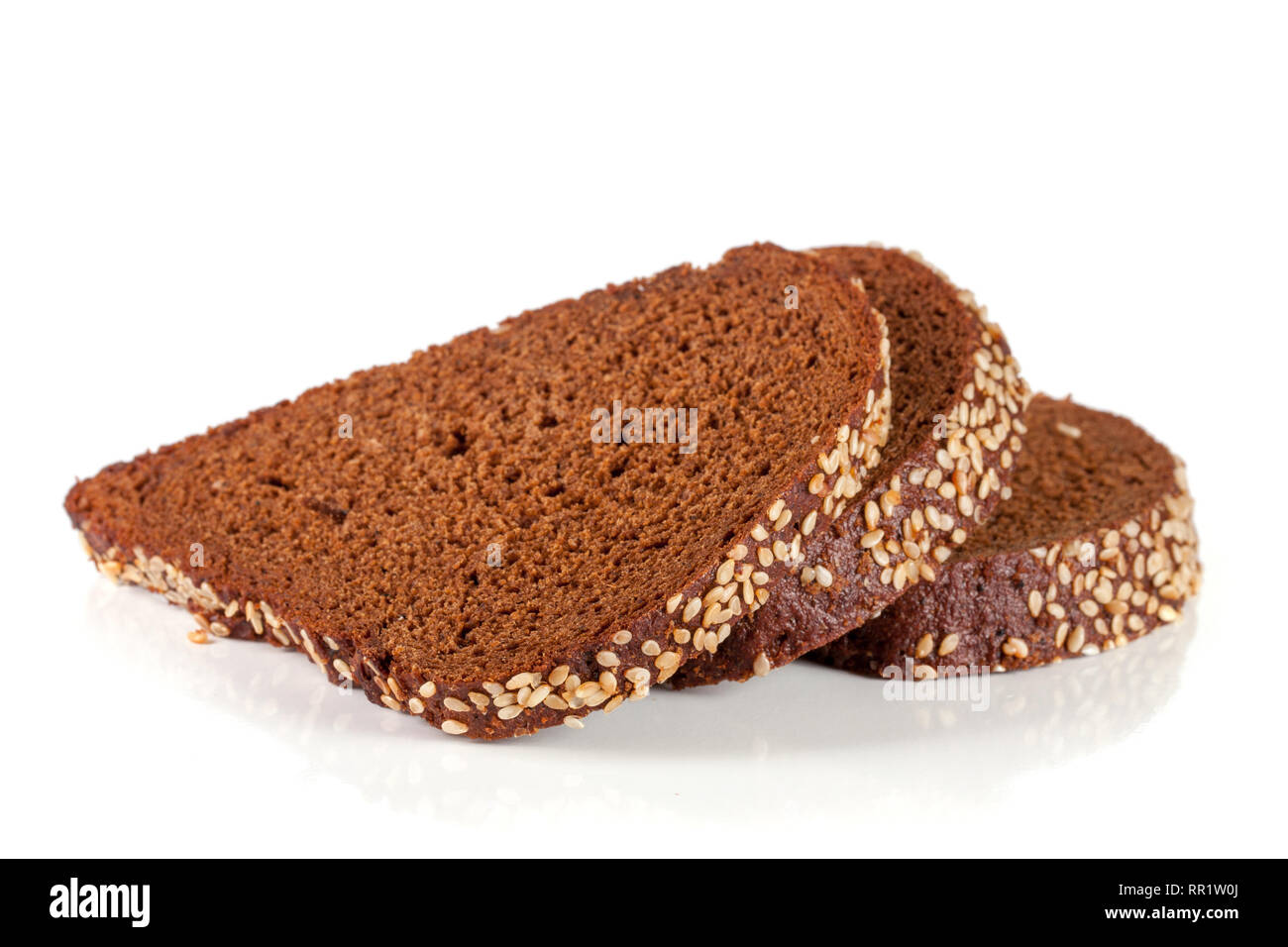 Three slices of black bread with sesame seeds isolated on white ...