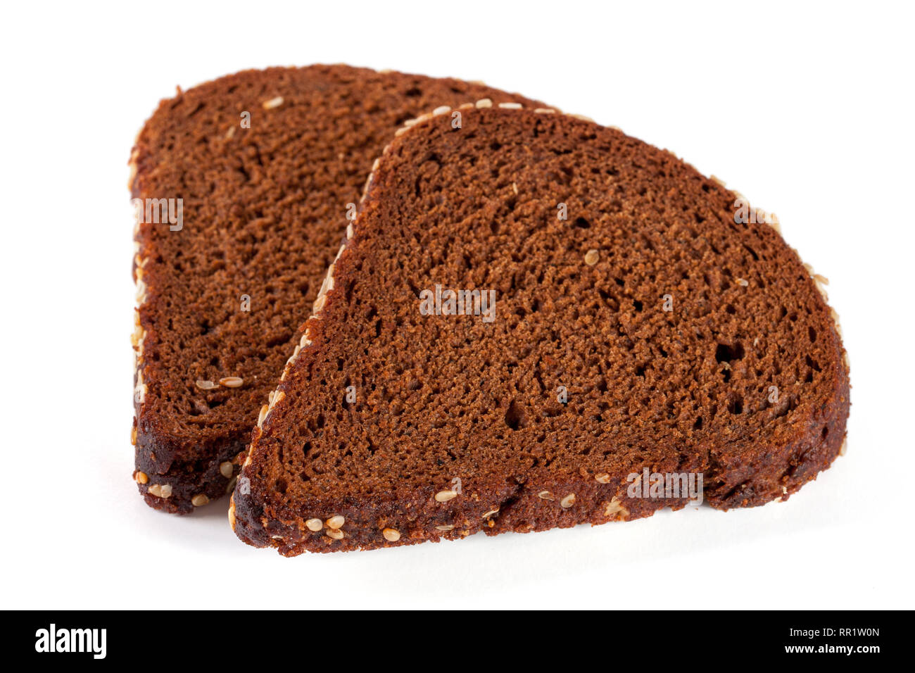 Two slices of black bread with sesame seeds isolated on white ...