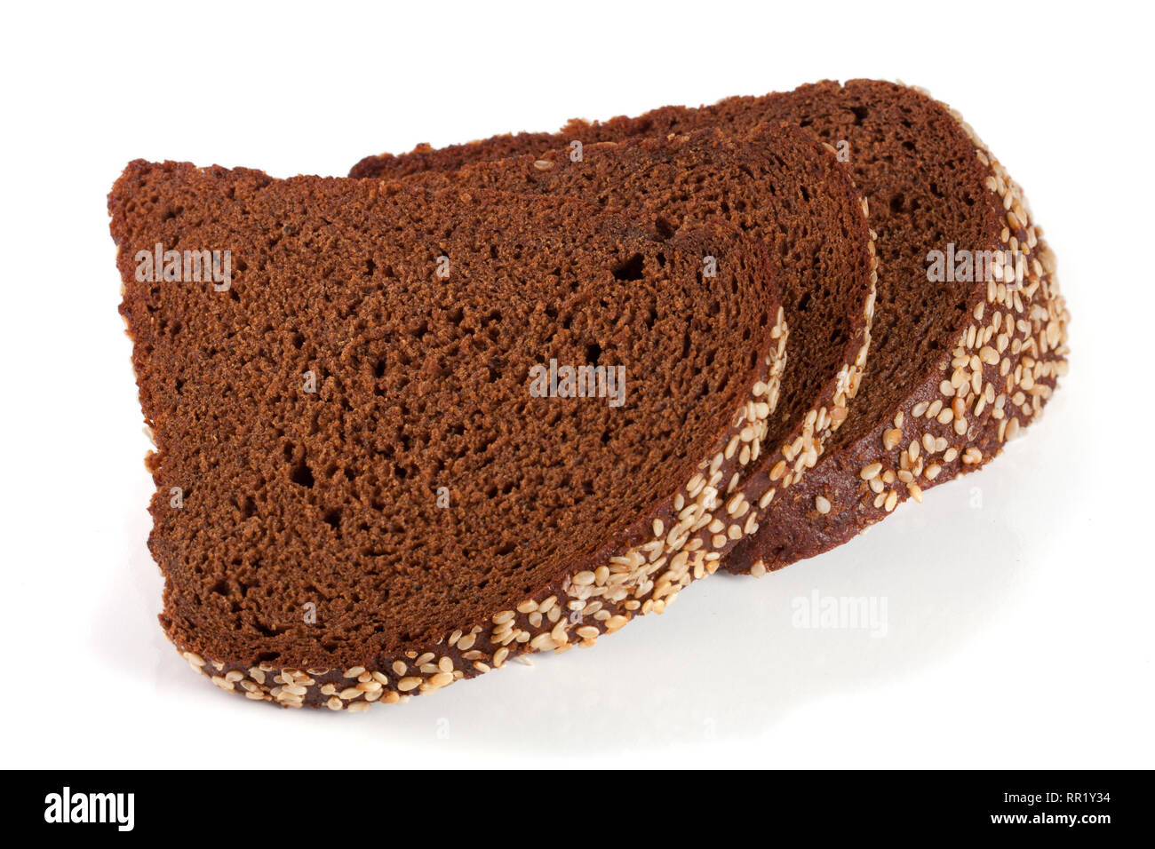 Three slices of black bread with sesame seeds isolated on white ...