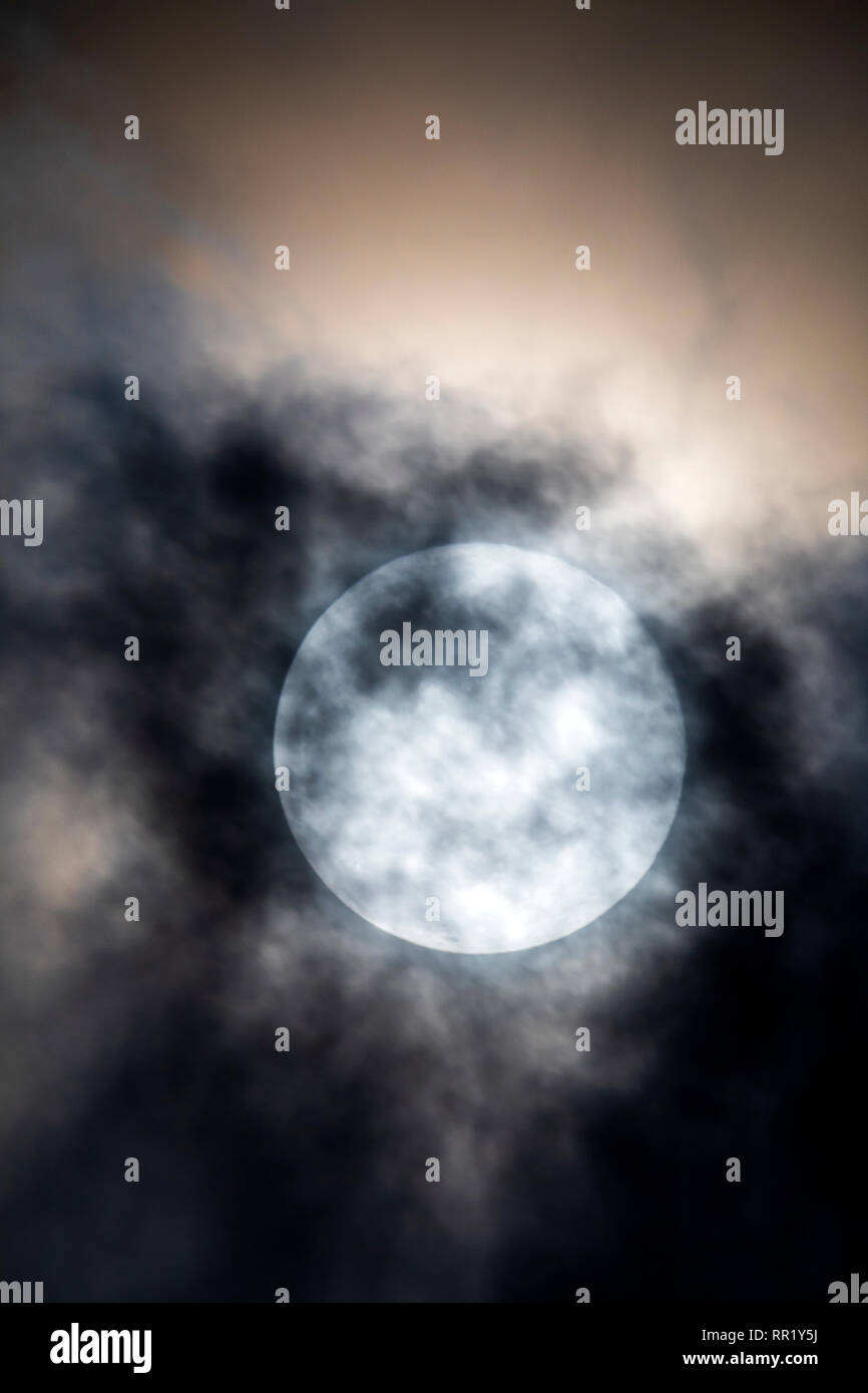 Snow Full Moon Rising Full super snow moon rises through clouds over Rocky Mountains, Salida ...
