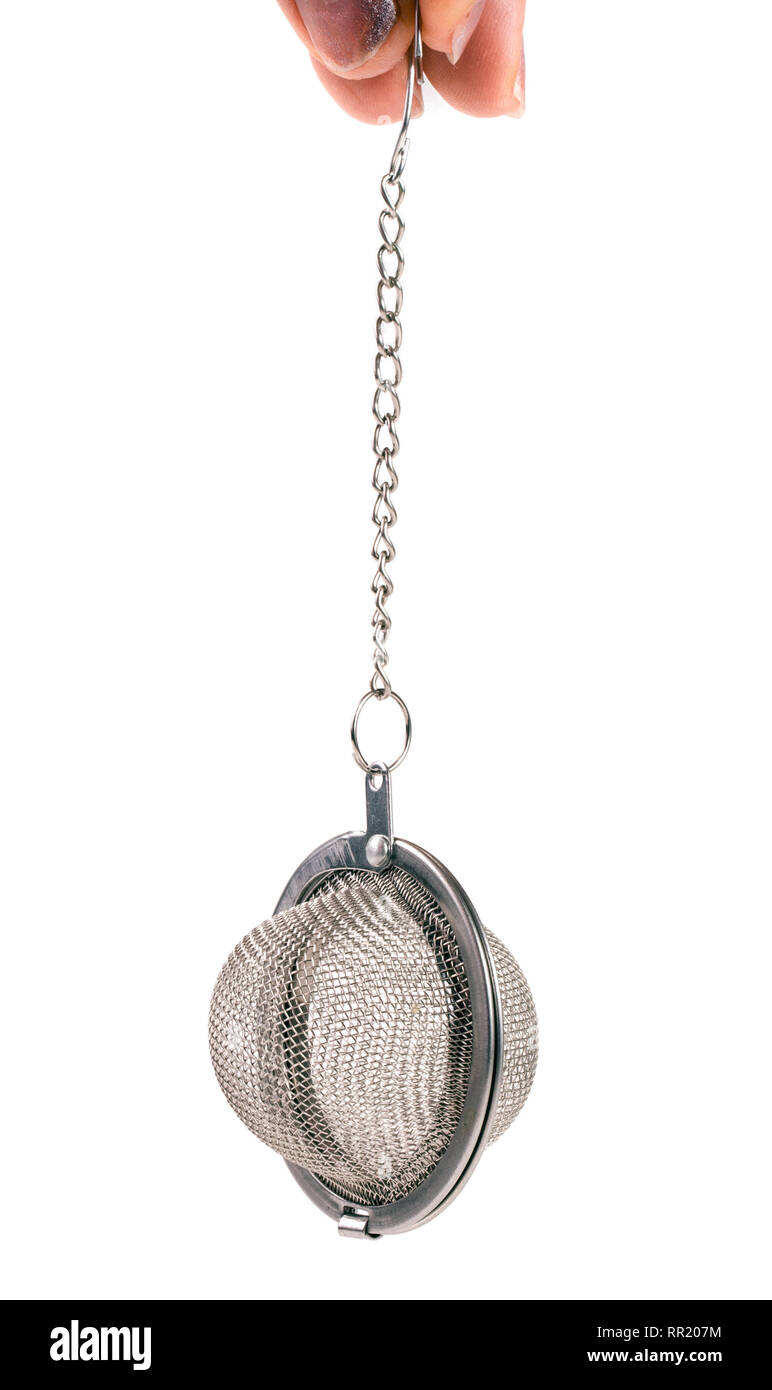 tea strainer on a chain in  hand isolated  white background Stock Photo