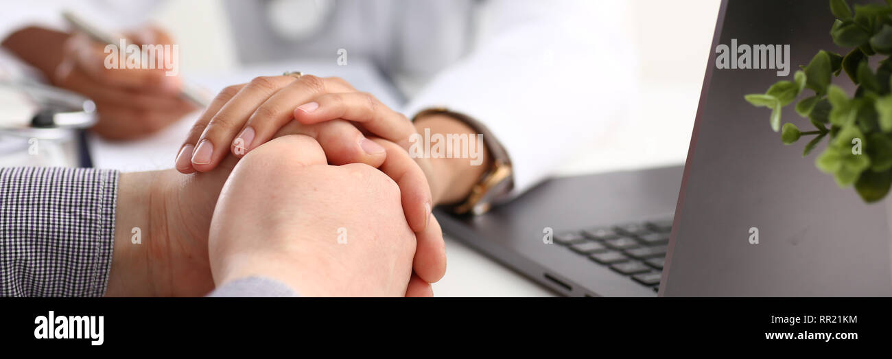 Friendly female doctor hold male patient Stock Photo