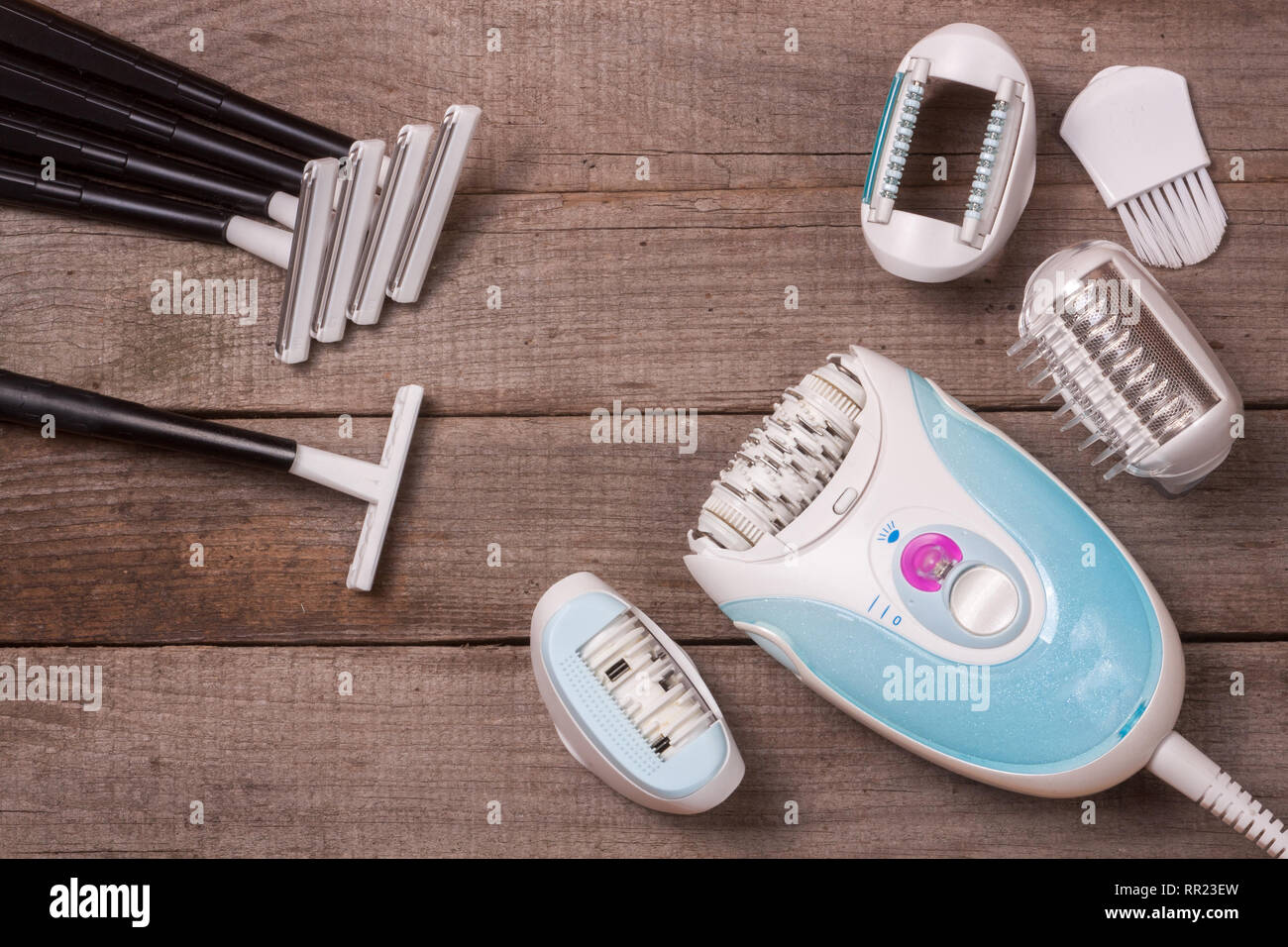 electric epilator with razor on a light wooden background Stock Photo ...