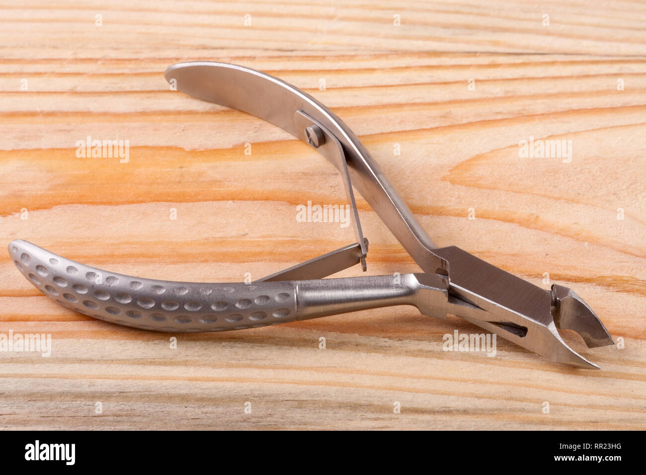 nail clippers to remove the cuticle and care products on a light wooden background Stock Photo
