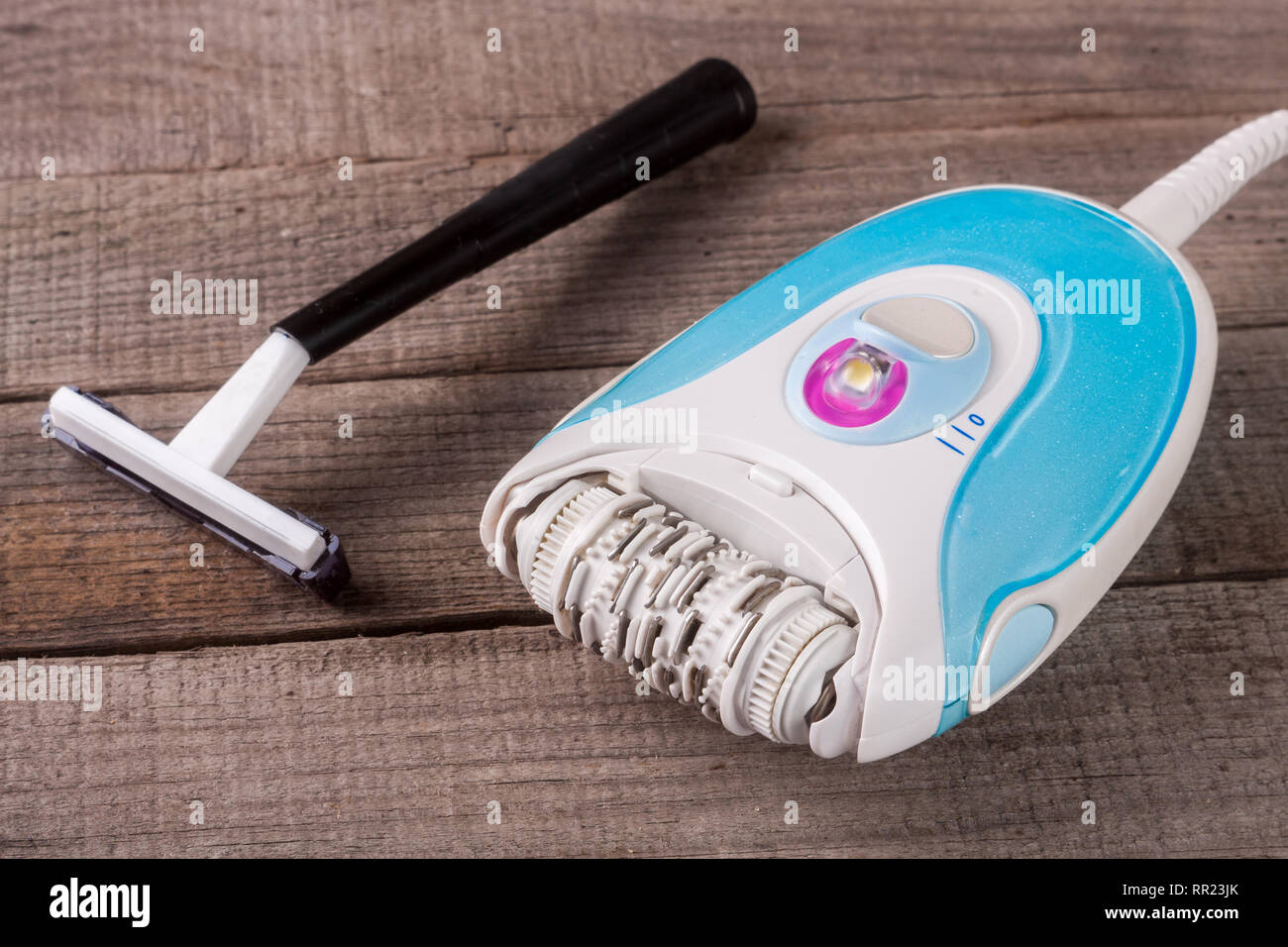 electric epilator with razor on a light wooden background Stock Photo ...