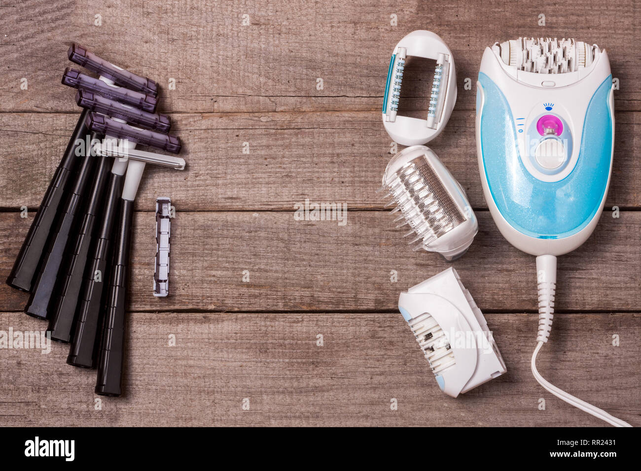 electric epilator with razor on a light wooden background Stock Photo ...