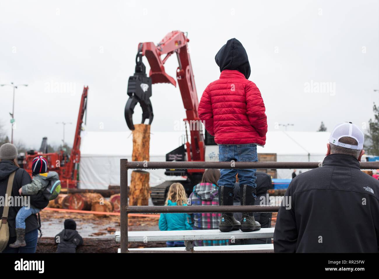Spectators watch a log stacking event at the Oregon Logging Conference