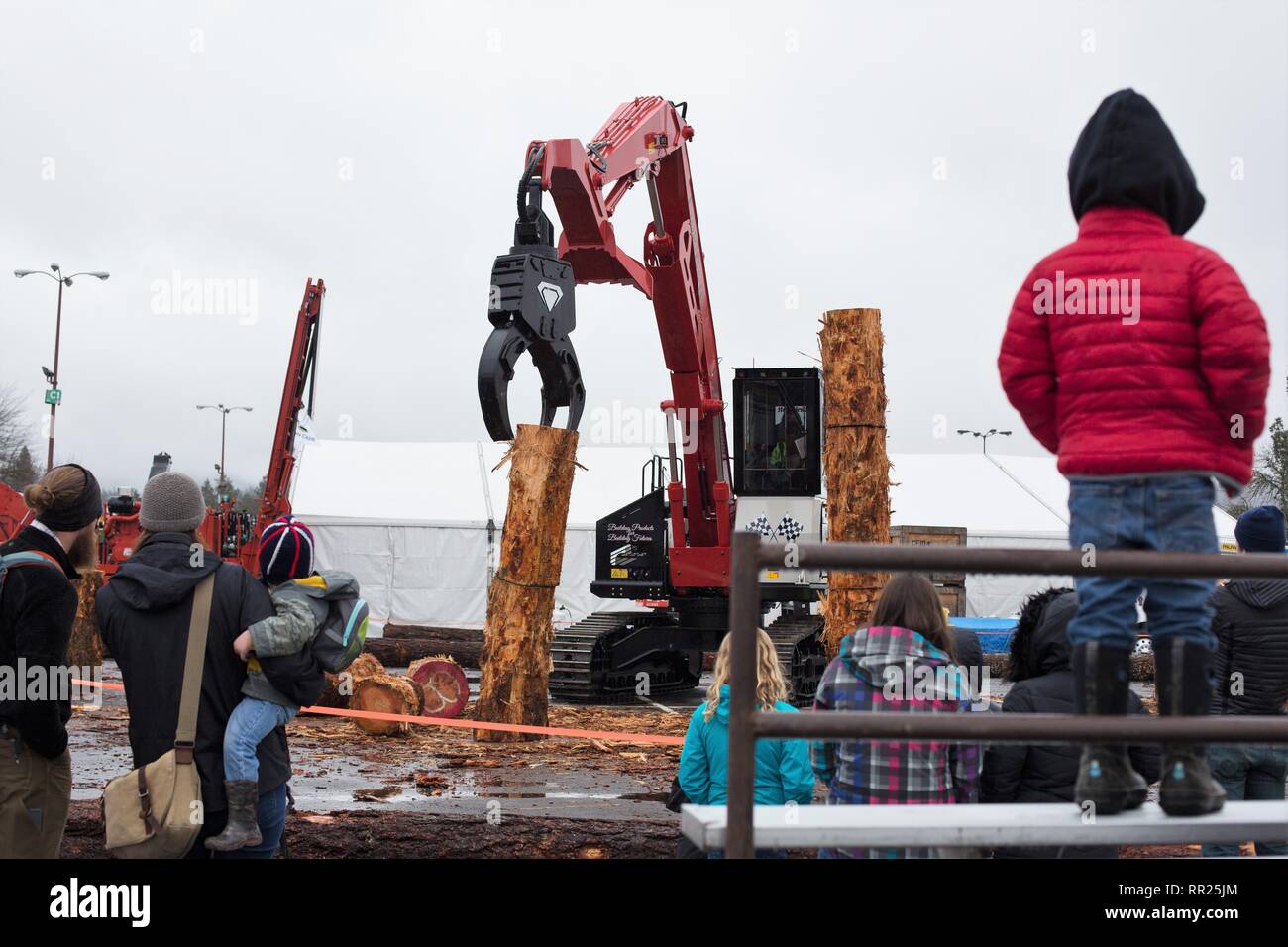 Spectators watch a log stacking event at the Oregon Logging Conference