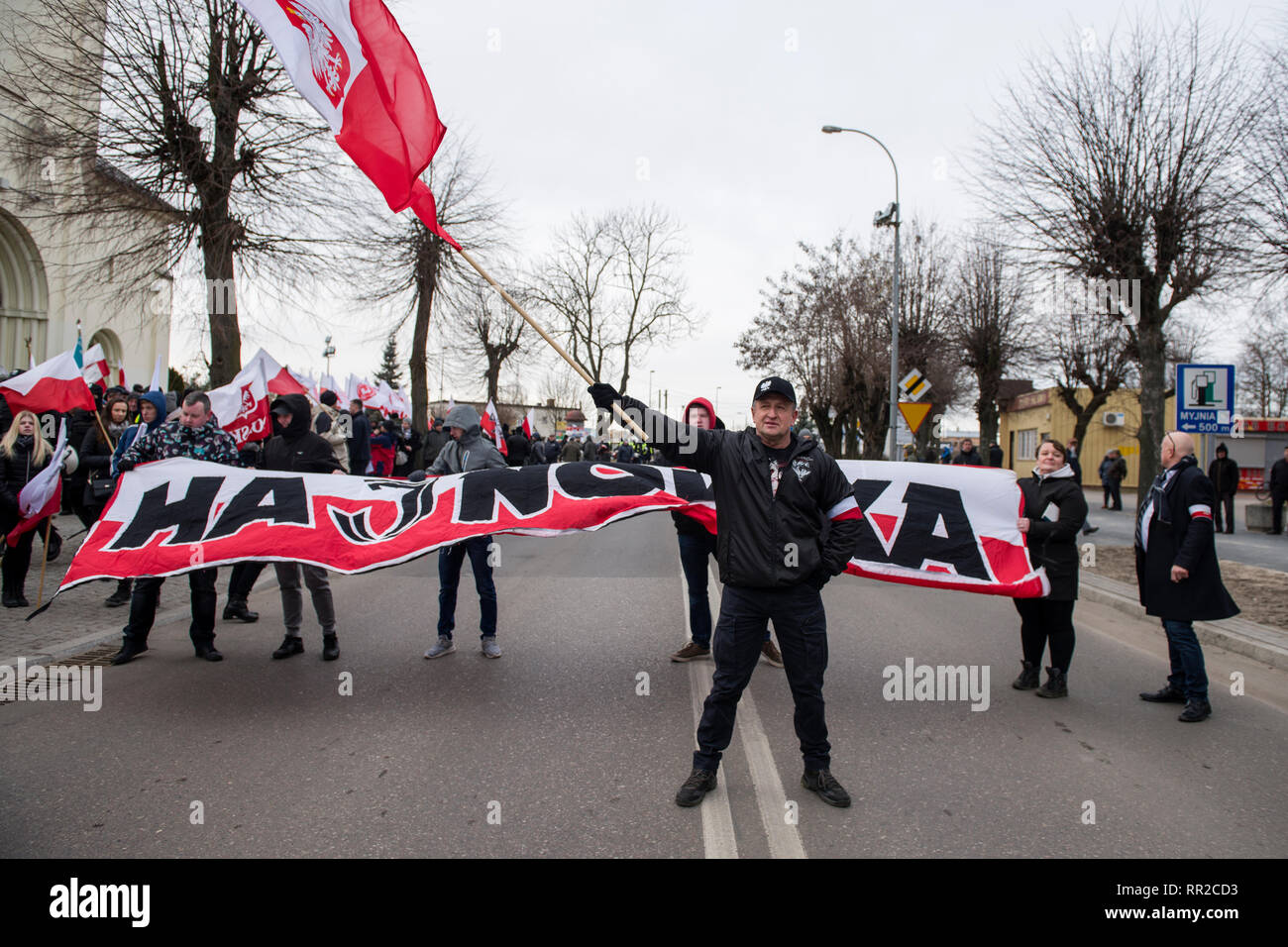 A nationalist is seen waving the Polish flag during the march. Polish nationalists organized a commemorative march of the “Cursed Soldiers” in the city of Hajnowka next to the Belarusian border. The Cursed Soldiers also known as the Doomed Soldiers were anti-communist resistant fighters after WWII, however they were also famous of committing crimes against civilians, mostly ethnic Belarusians. Stock Photo
