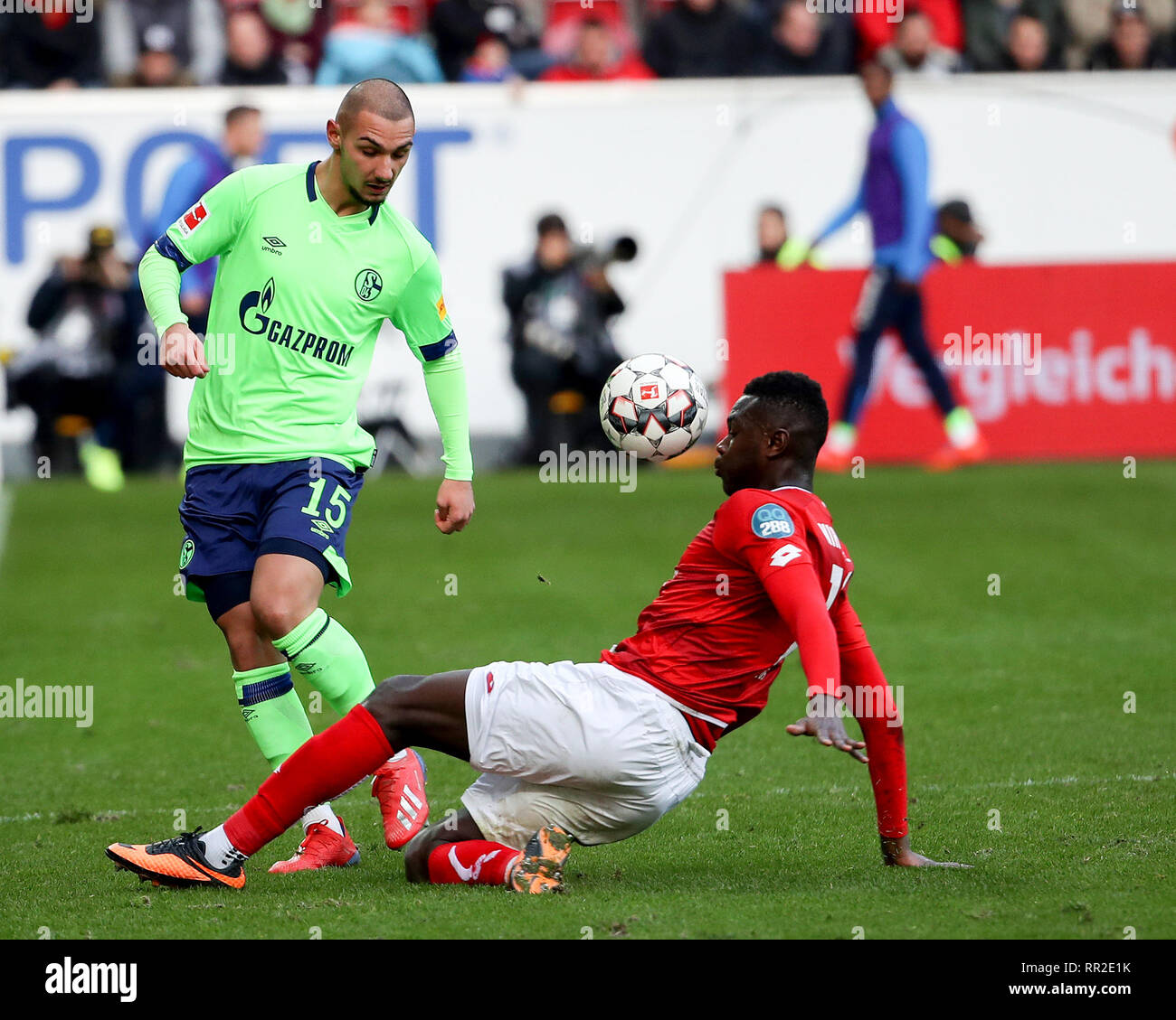 Mainz, Germany. 23rd Feb, 2019. Achmed Kutucu (L) of Schalke 04 vies with  Moussa Niakate of Mainz during the Bundesliga match between FSV Mainz 05  and FC Schalke 04 in Mainz, Germany,