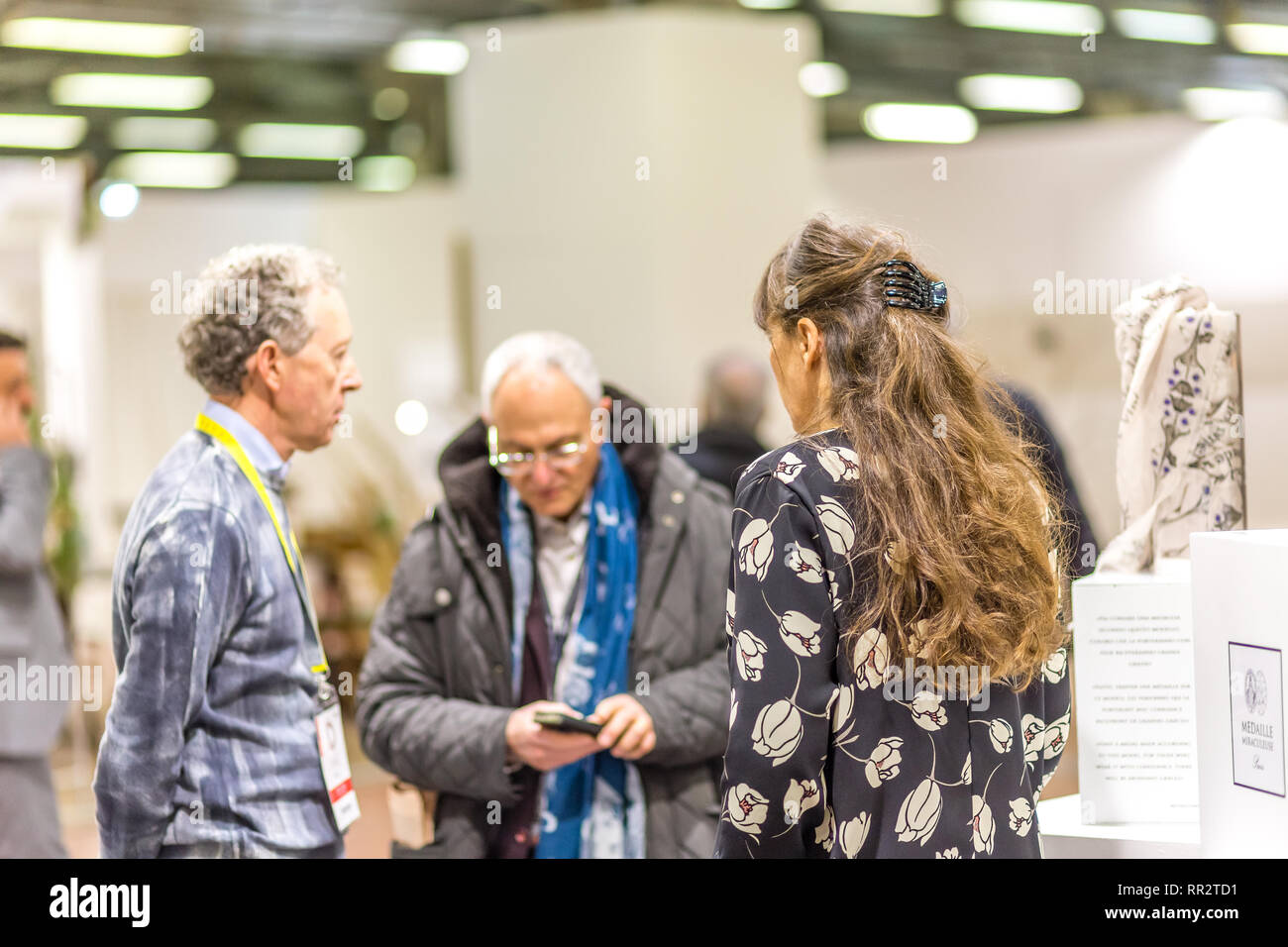 BOLOGNA, ITALY - FEBRUARY 18, 2019: booth presenter talking with visitor at stand of MEDAILLE MIRACULEUSE in DEVOTIO Religious products and service ex Stock Photo