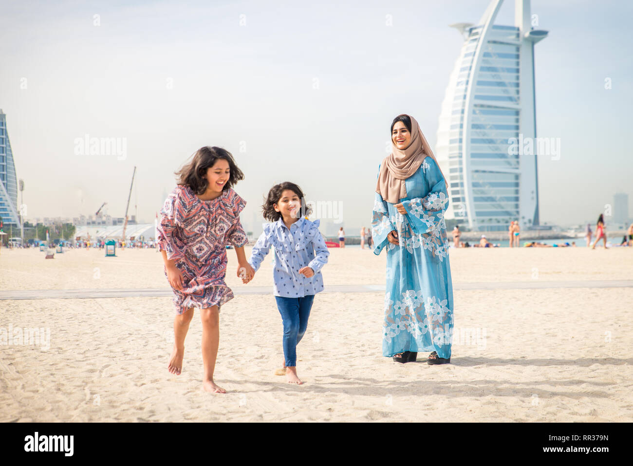 Happy arabian family having fun in Dubai Mom together with her