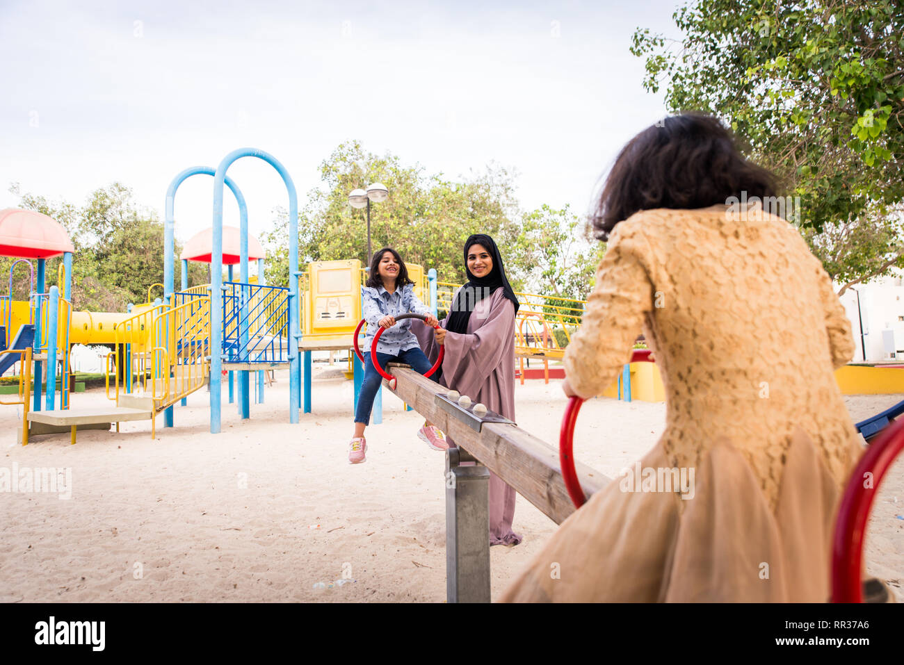 Happy arabian family having fun in Dubai Mom together with her