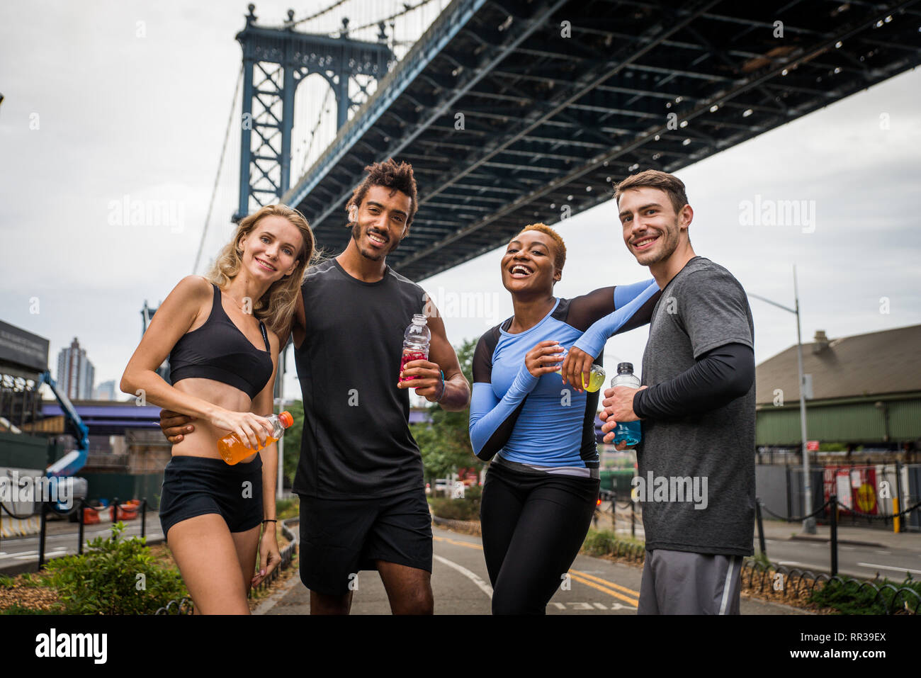 Multi-ethnic group of runners training outdoors - Sportive people running on the street of Manhattan, concepts about sport and healthy lifestyle Stock Photo
