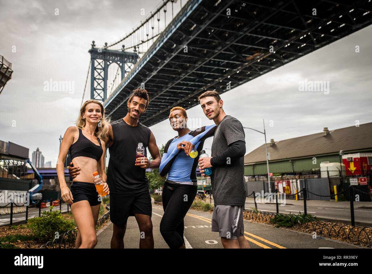 Multi-ethnic group of runners training outdoors - Sportive people running on the street of Manhattan, concepts about sport and healthy lifestyle Stock Photo
