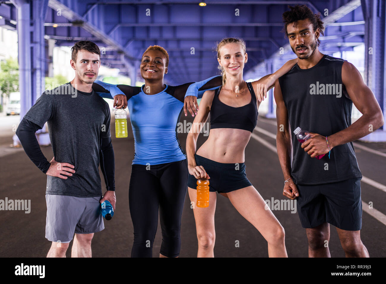 Multiethnic group of runners training outdoors Sportive people