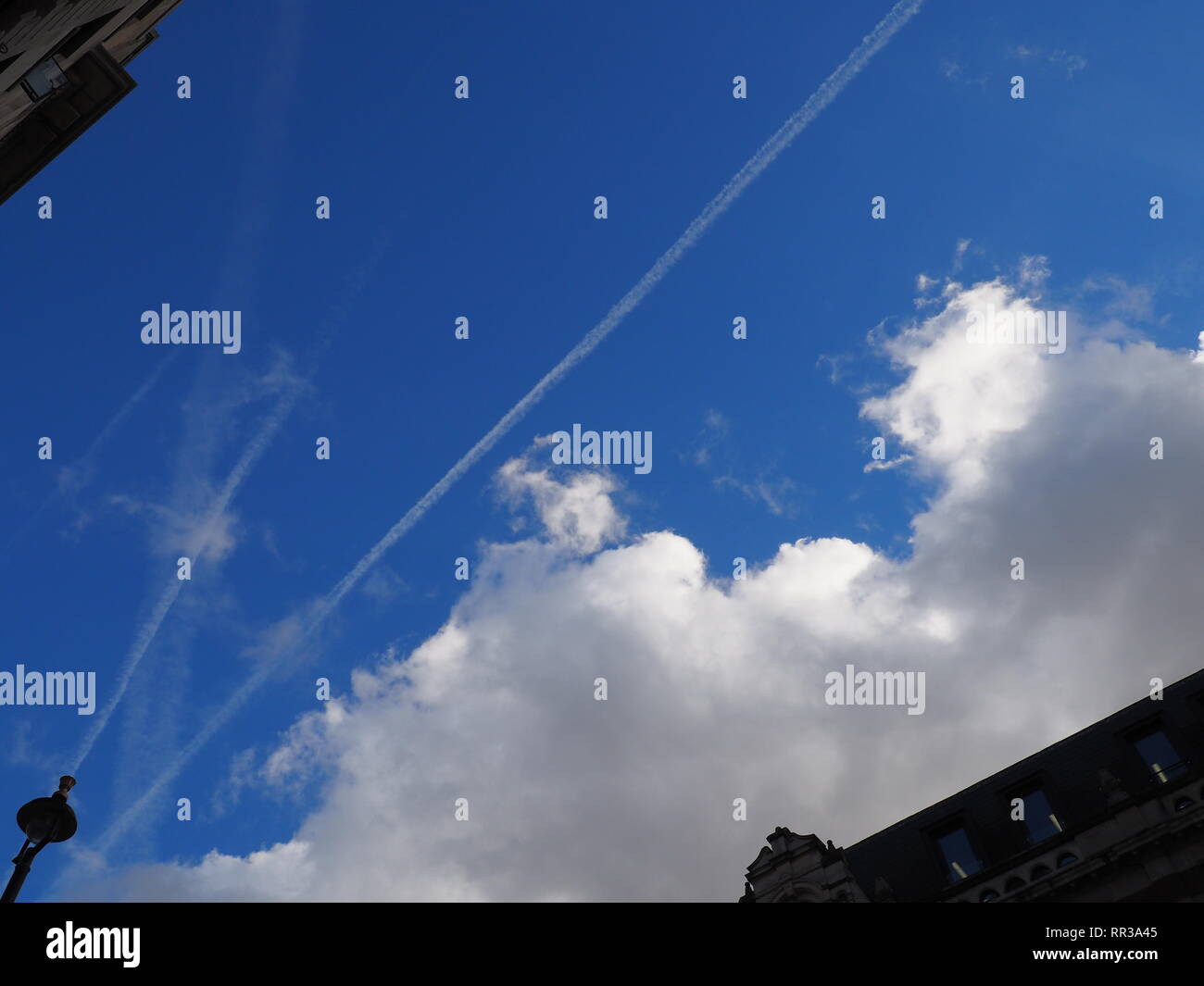 Geo-engineering spray to form clouds over Oxford Street,London. Jets spraying in the Spring sky. Stock Photo