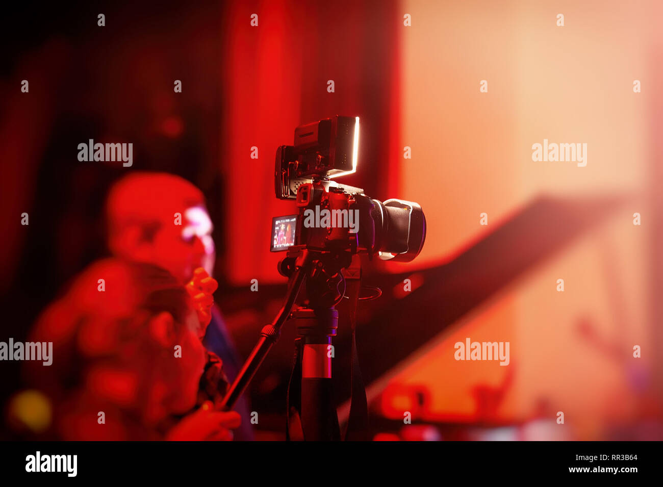 videographers are shooting during the concert. Reporting in the room