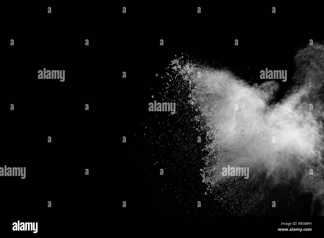 White powder explosion isolated on black background. White dust ...