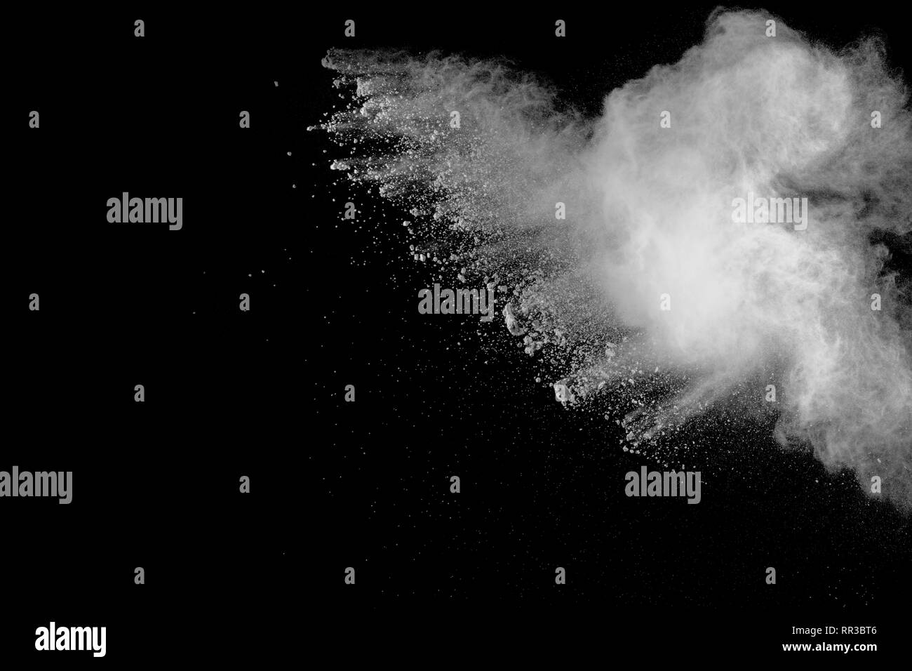 White powder explosion isolated on black background. White dust ...