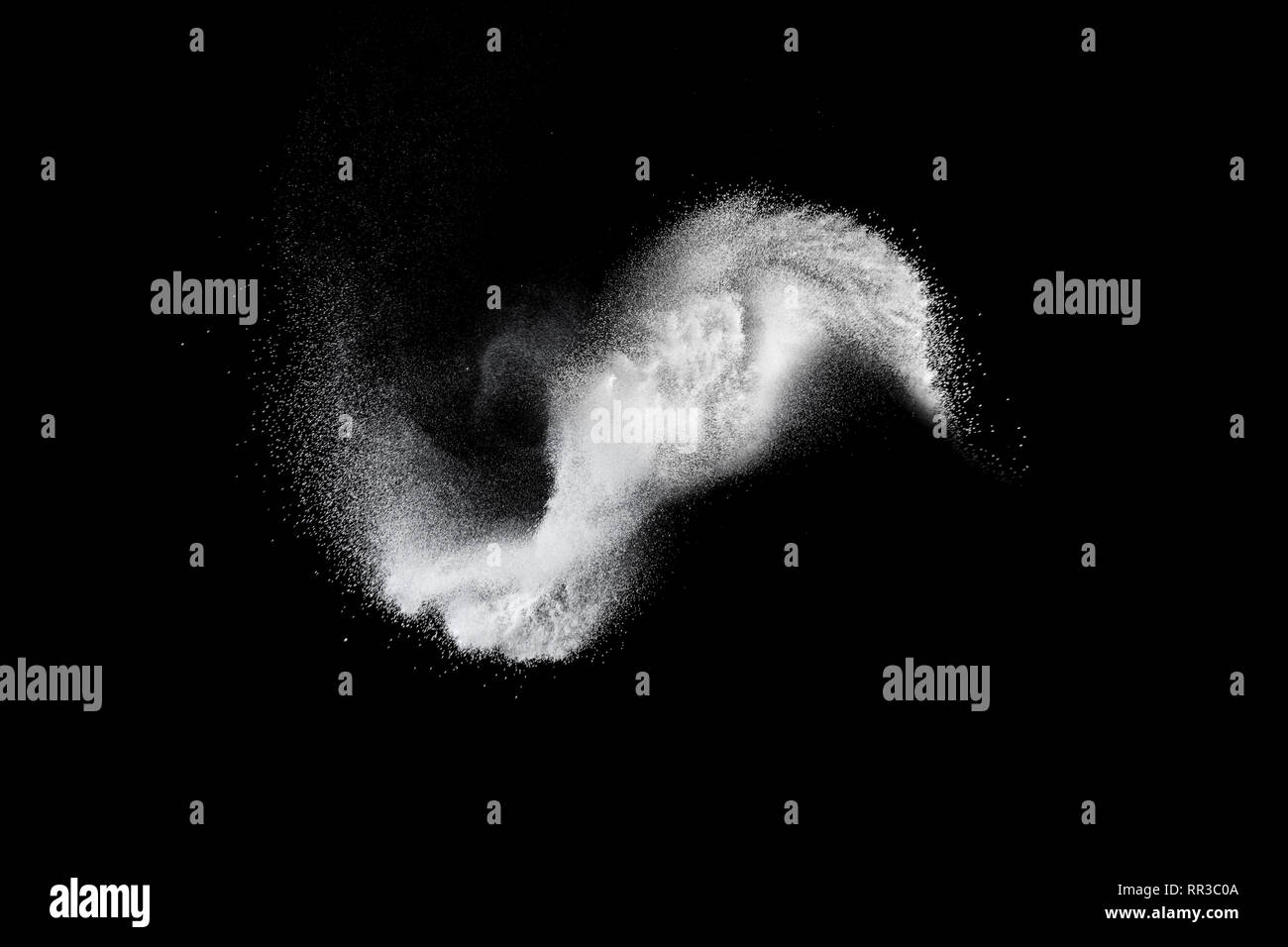 White powder explosion isolated on black background. White dust ...