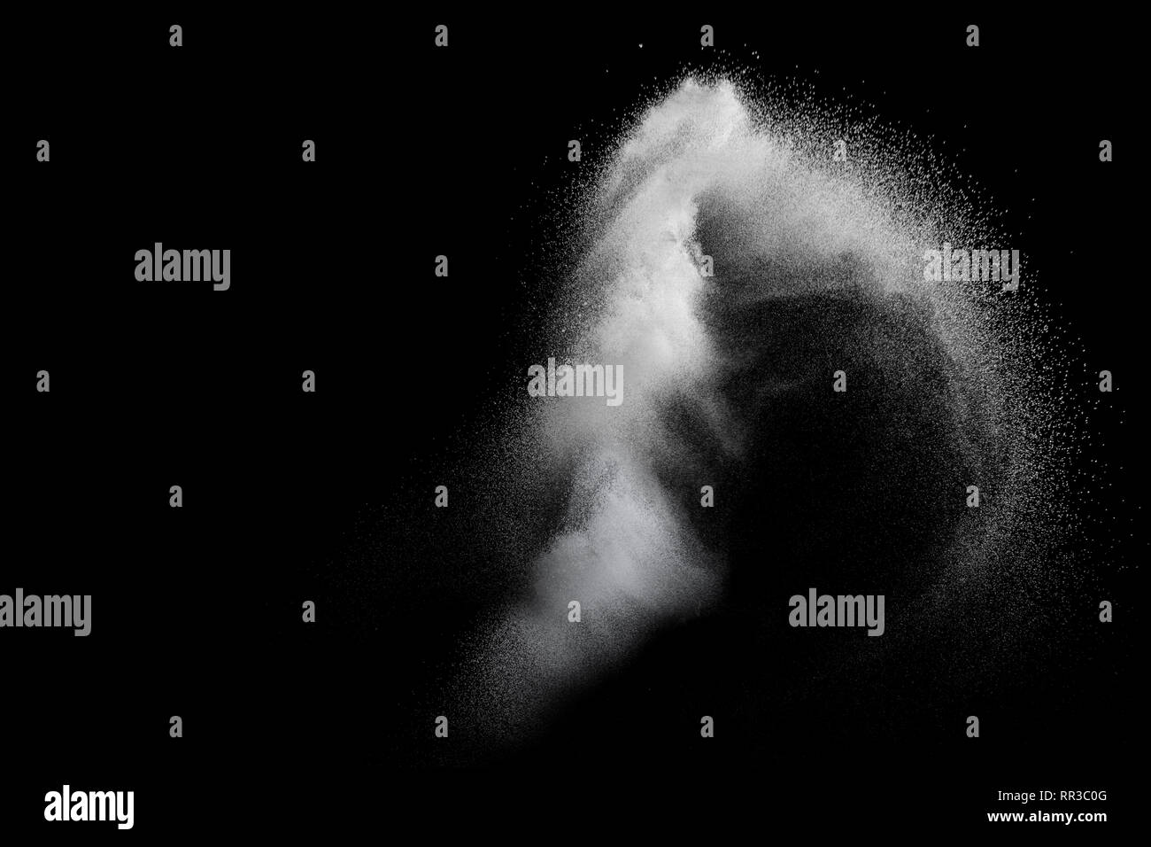 White powder explosion isolated on black background. White dust ...