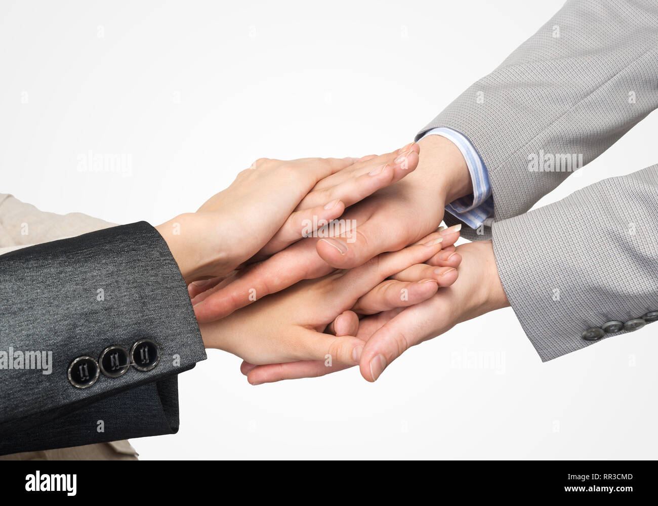 Close up of businesspeople putting their hands together against white