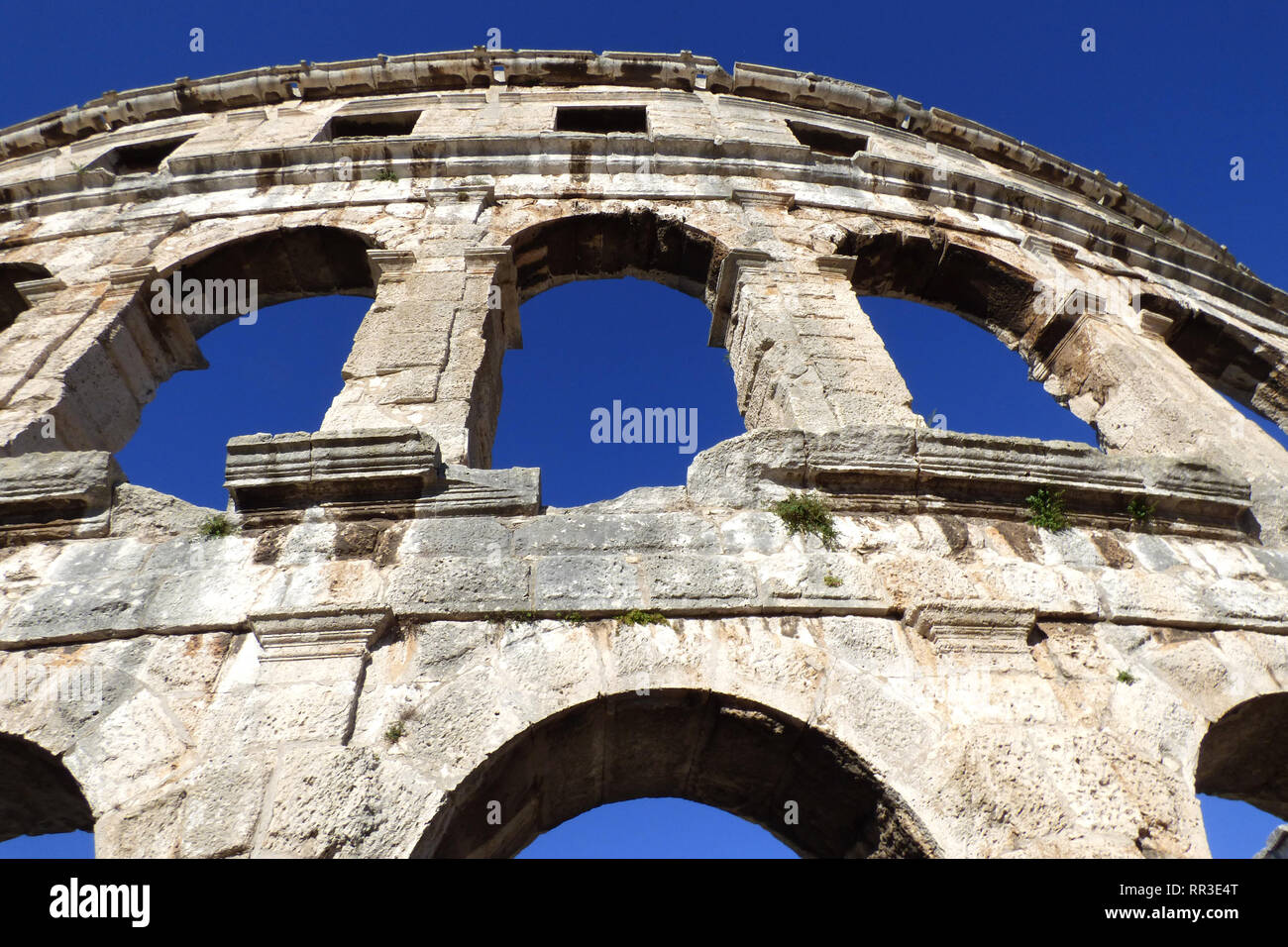 Pula pola colosseum architecture details with arched windows summertime Stock Photo