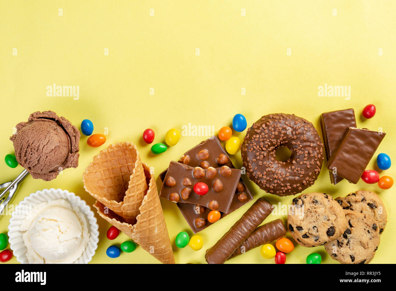Selection of colorful sweets - chocolate, donuts, cookies, lollipops, ice cream Stock Photo