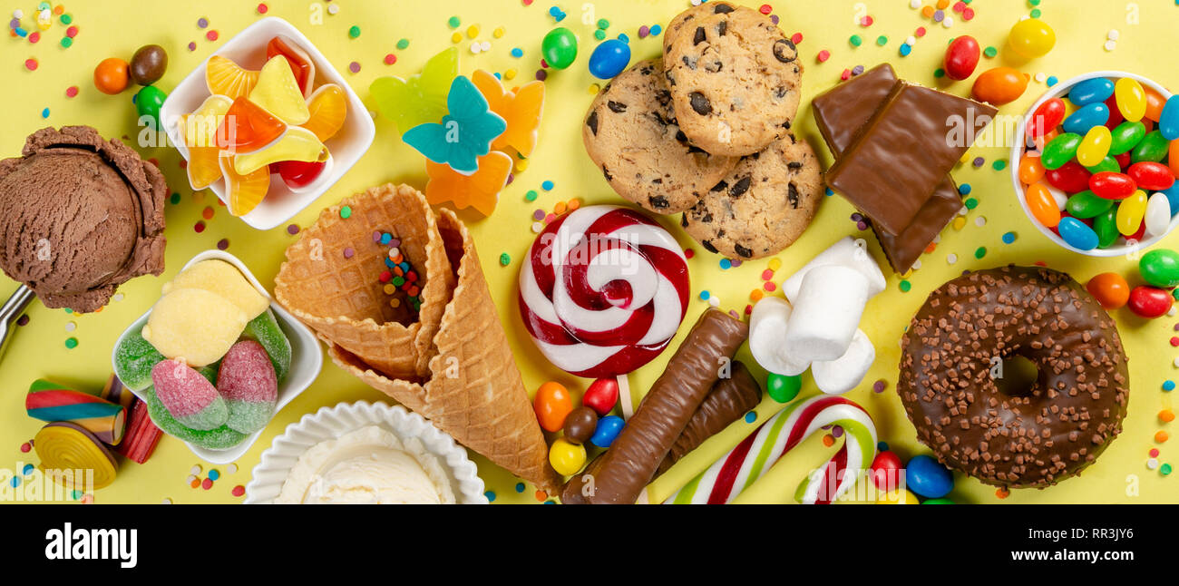 Selection of colorful sweets - chocolate, donuts, cookies, lollipops, ice cream Stock Photo