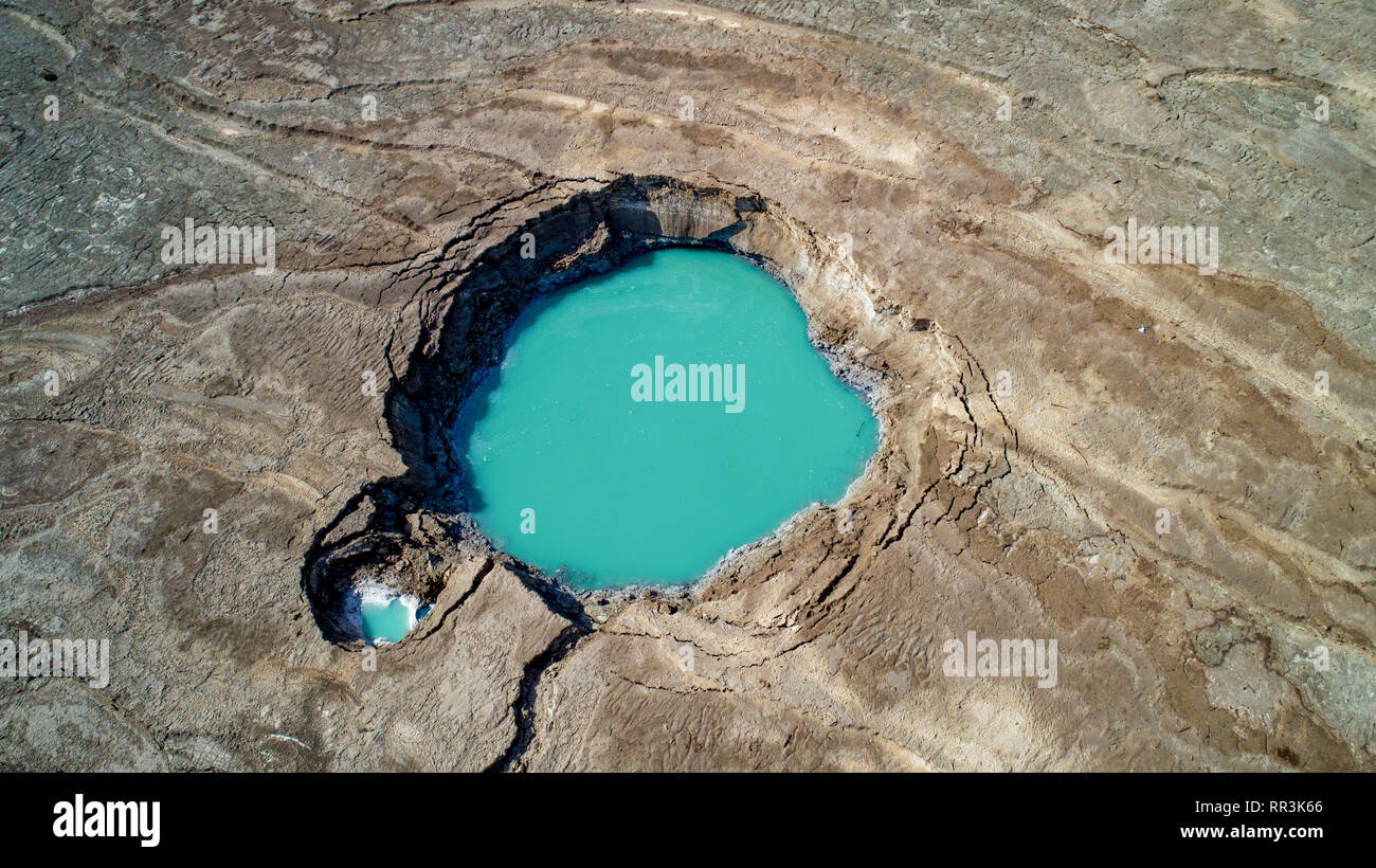 Aerial Photography with a drone. Elevated view of sink holes on the shore of the Dead Sea, Israel. The sink holes are caused by the rapidly receding w Stock Photo