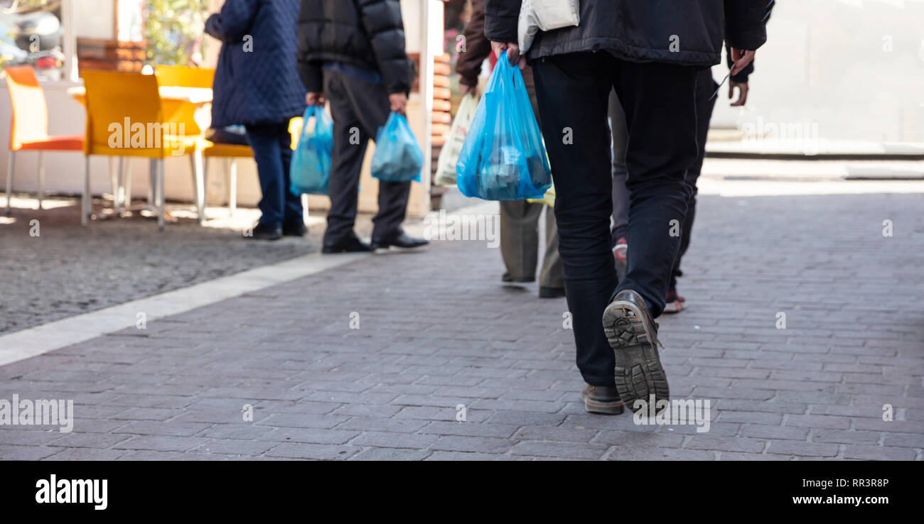 Plastic bags use. People hoding plastic bags. Closeup view, copy space Stock Photo