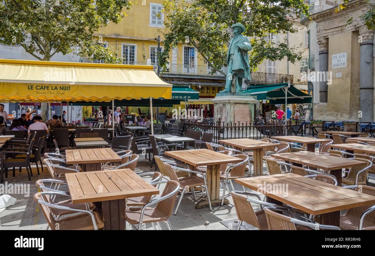 FRANCE ARLES SEP 2018  a view of the exterior of le cafe la nuit (the Night cafe) and the statuse of Van Gogh in Arles city of Provence France Stock Photo