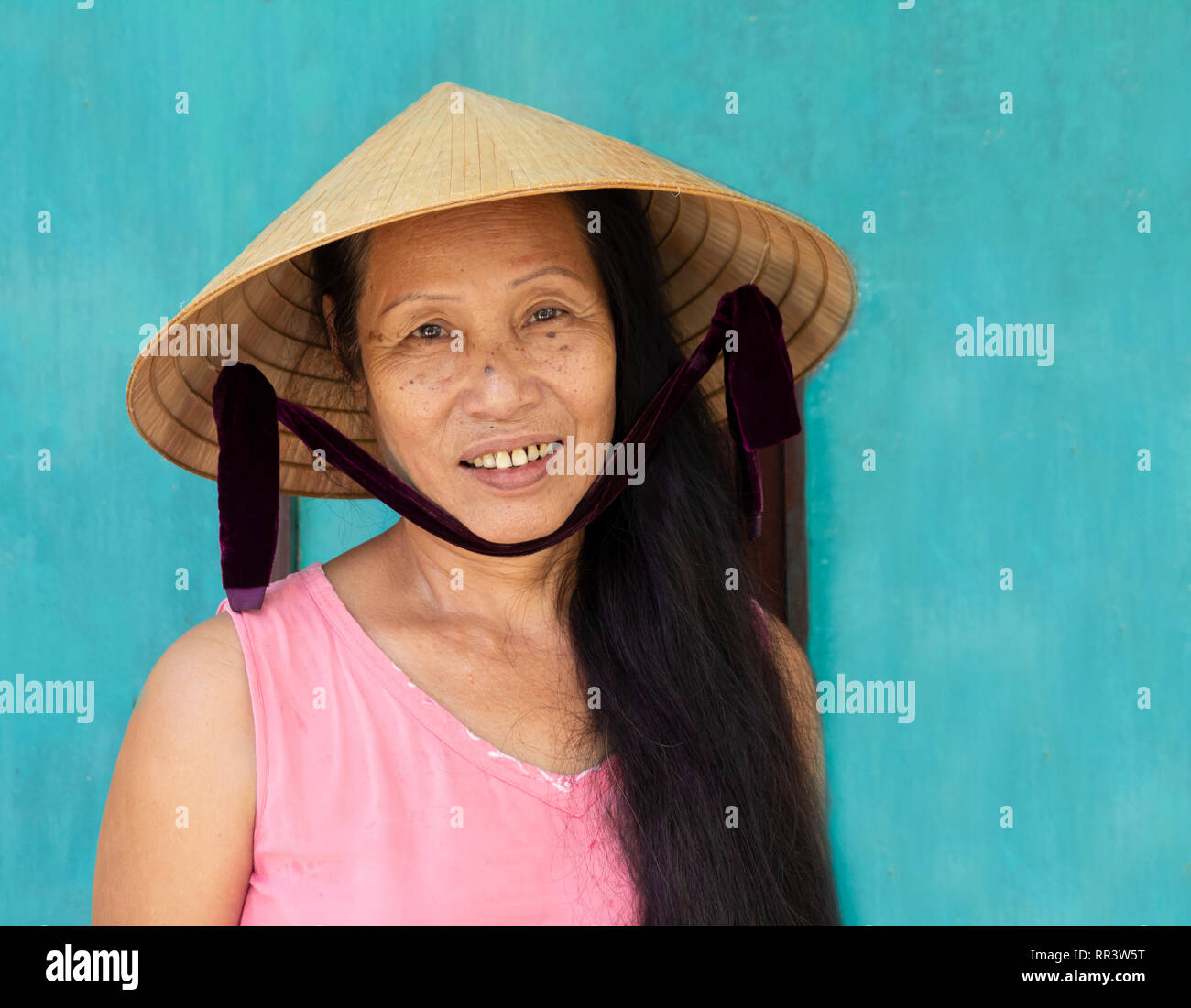 closeup face portrait of vietnamese woman wearing conical hat Stock Photo