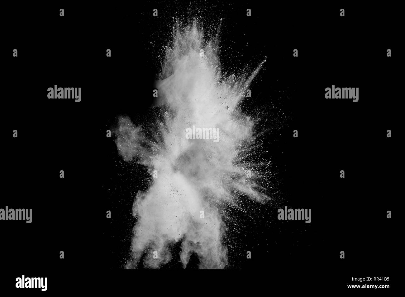 White powder explosion isolated on black background. White dust ...