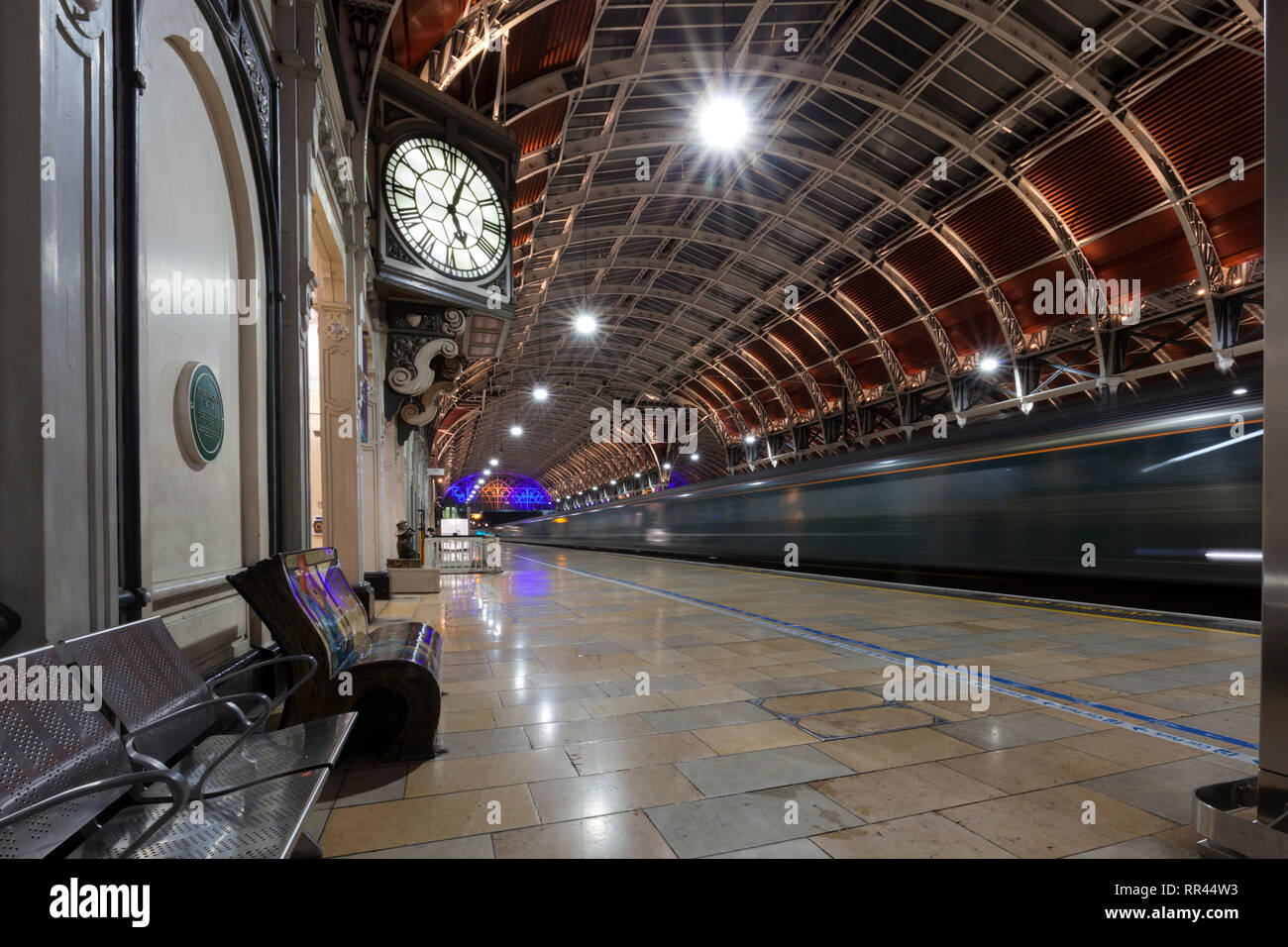 The  First Great Western night Riviera sleeper train from Penzance arriving at London Paddington Station with the station clock just after 5AM Stock Photo