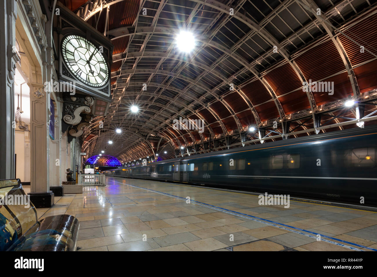 The  First Great Western night Riviera sleeper train from Penzance arriving at London Paddington Station with the station clock just after 5AM Stock Photo