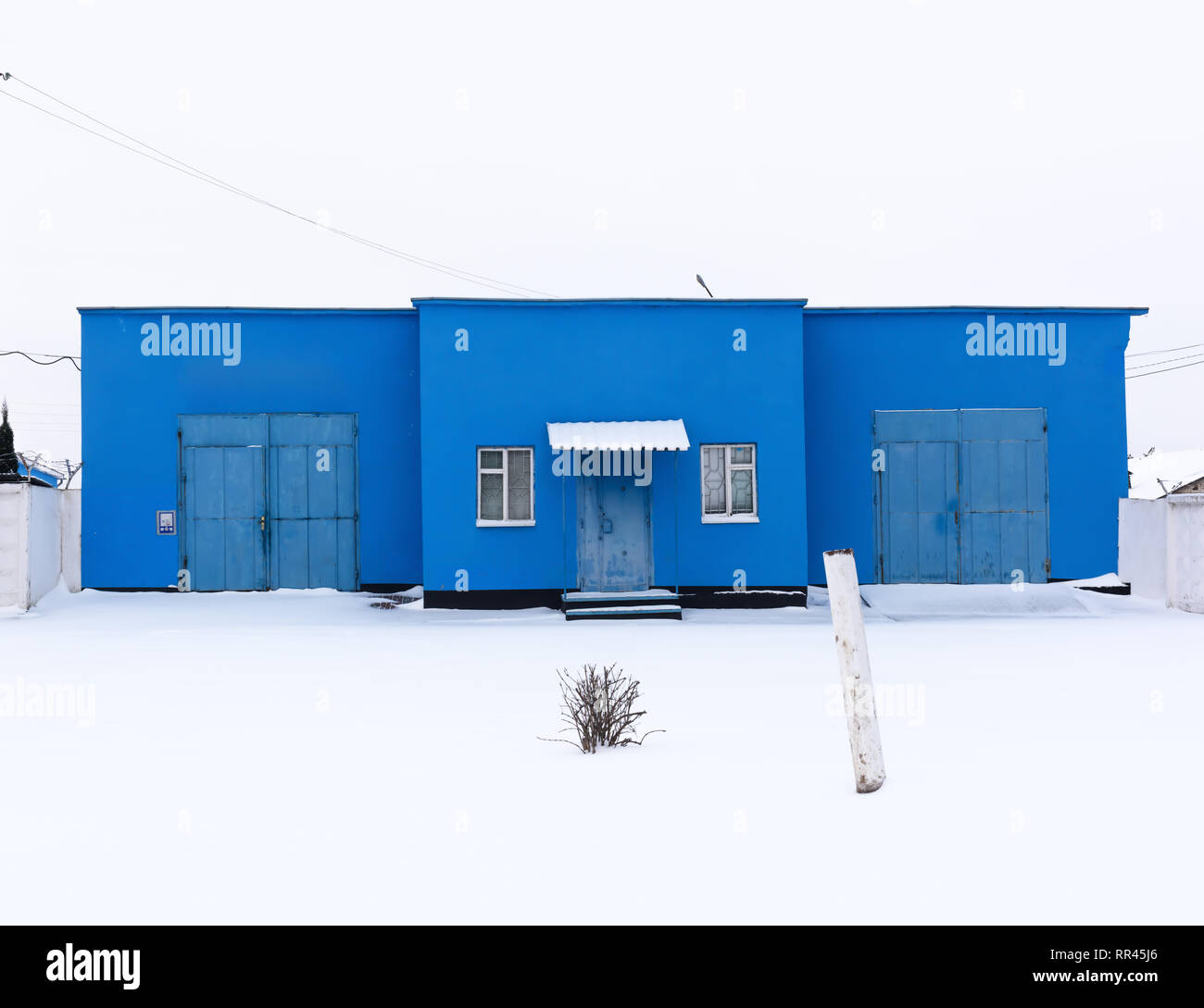 Blue building on snowy street. Post soviet architecture Stock Photo