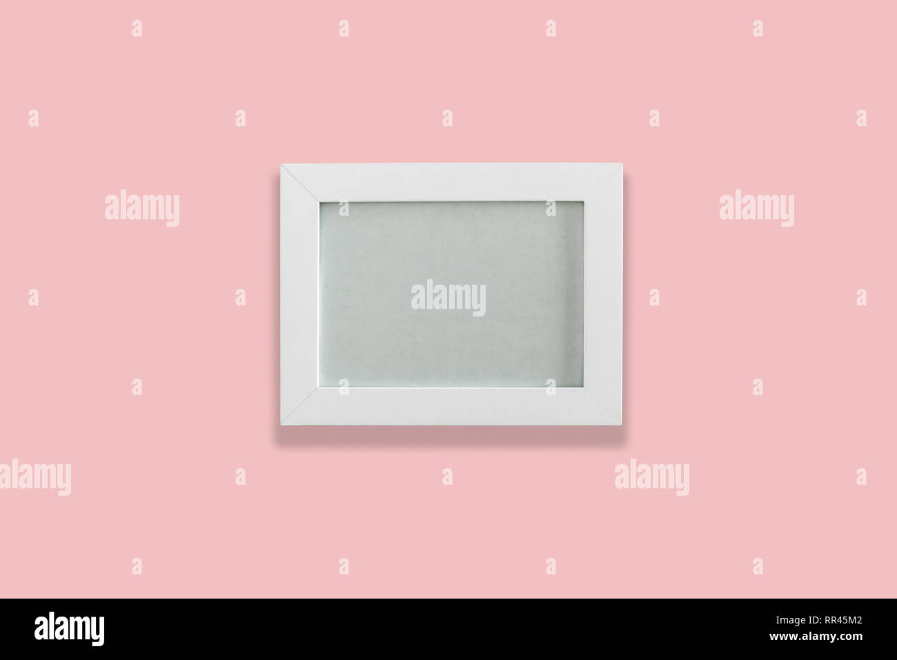 White empty photo frame on pink background Stock Photo