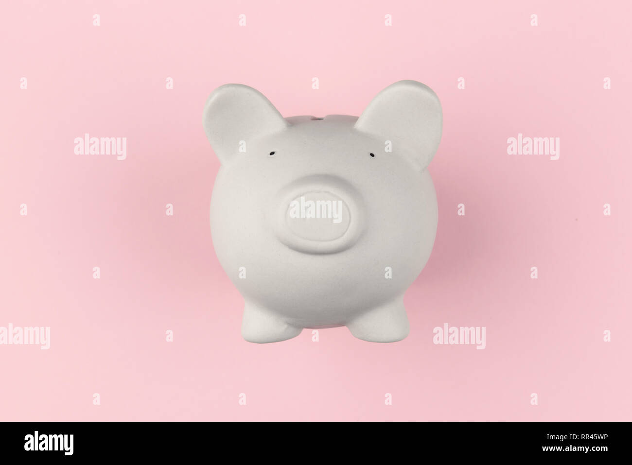 White piggy moneybox on pink background. Financial concept Stock Photo