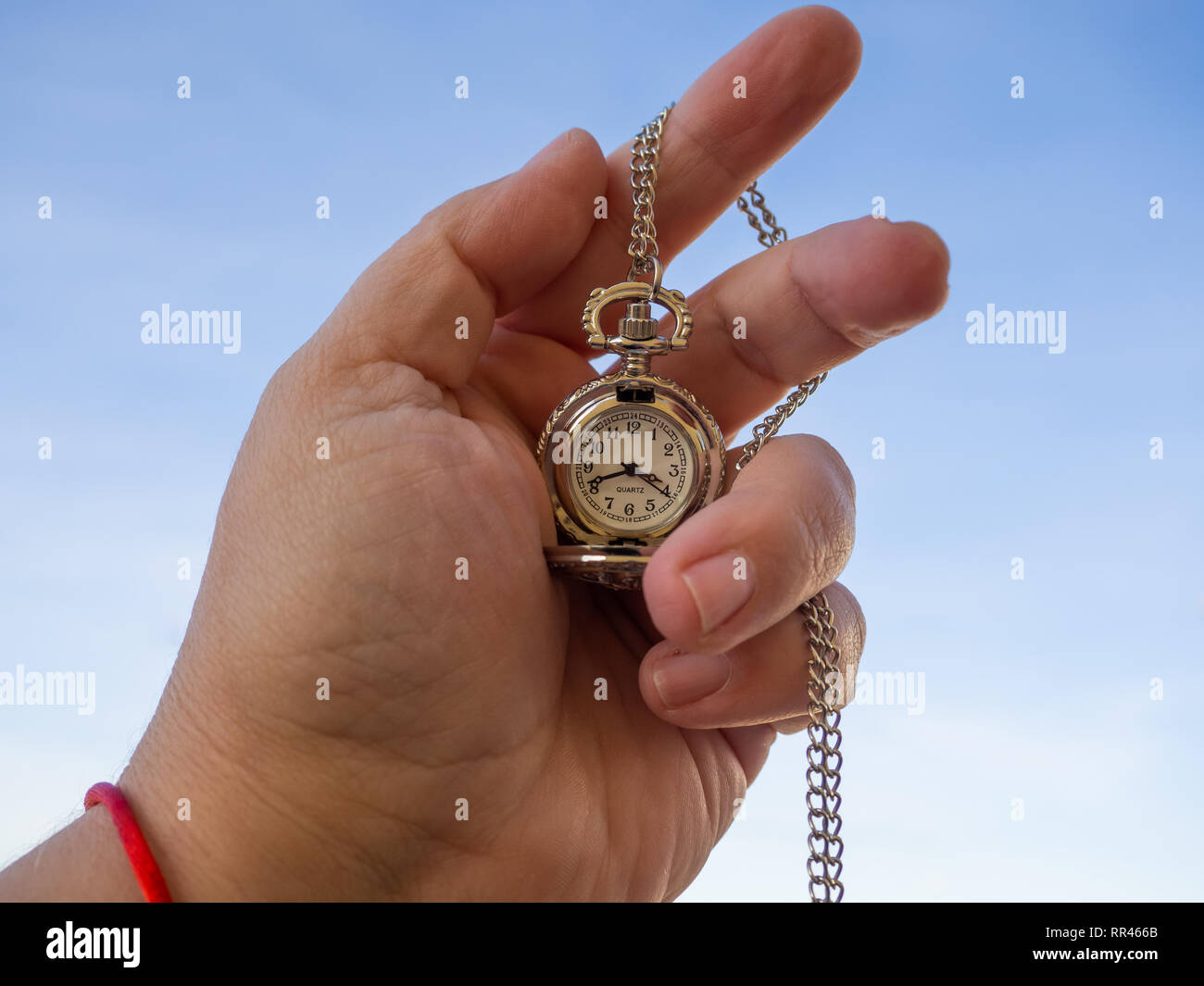 One person with one antique chain watch plated in his hand Stock Photo