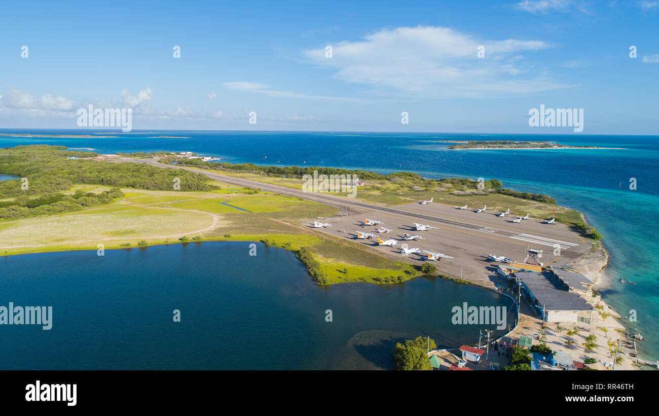 Tropical island Airport with airplanes parked in Los Roqus National Park.. Aerial View Stock Photo