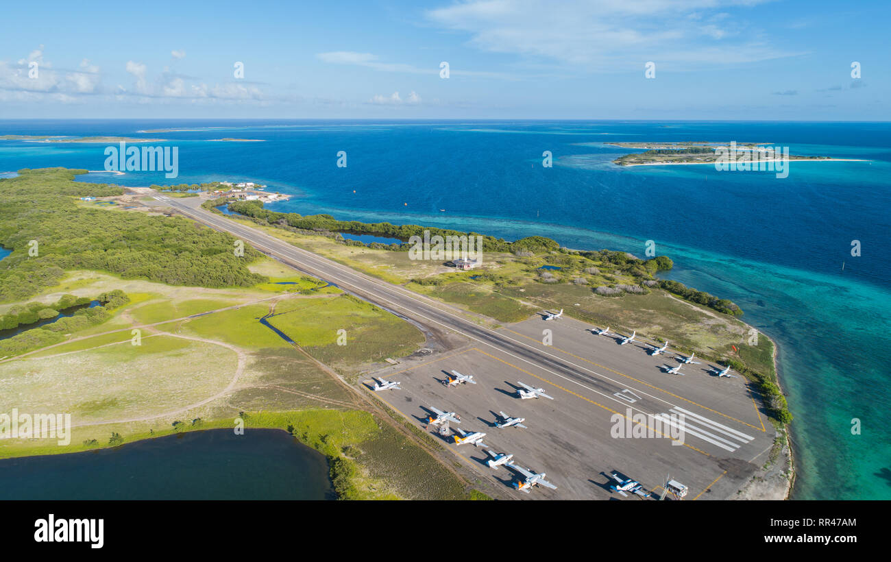 Airport with small airplanes parked in Los Roques islands National Park Venezuela. Aerial View Stock Photo