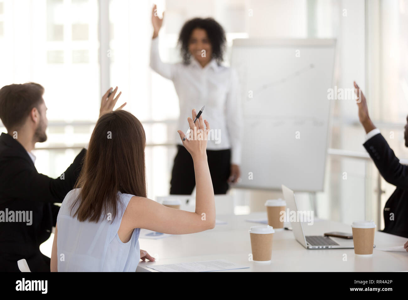Diverse group of business people voting at meeting Stock Photo Alamy