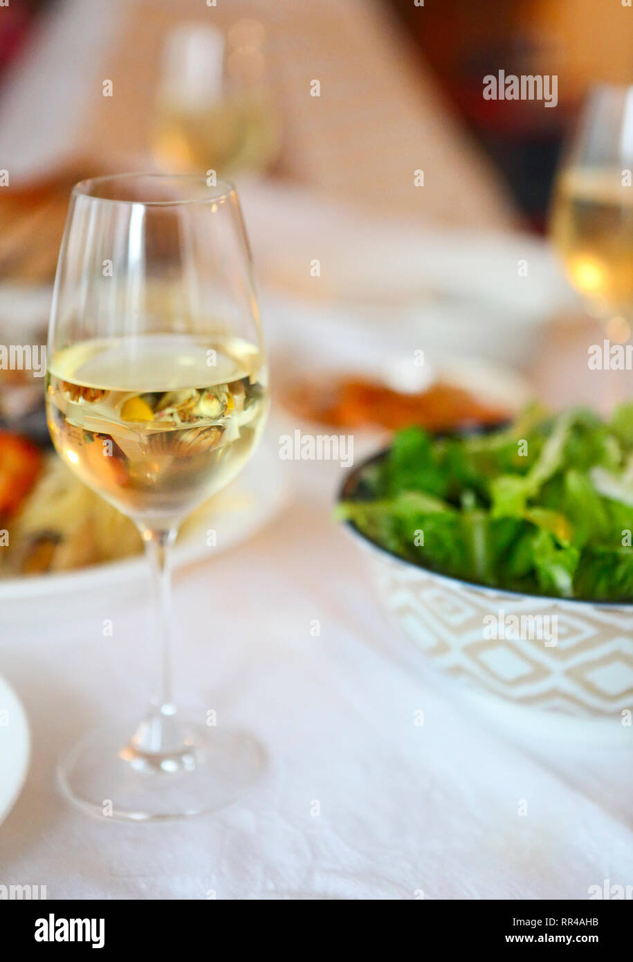 People fine dining seafood and white wine on the table. Stock Photo
